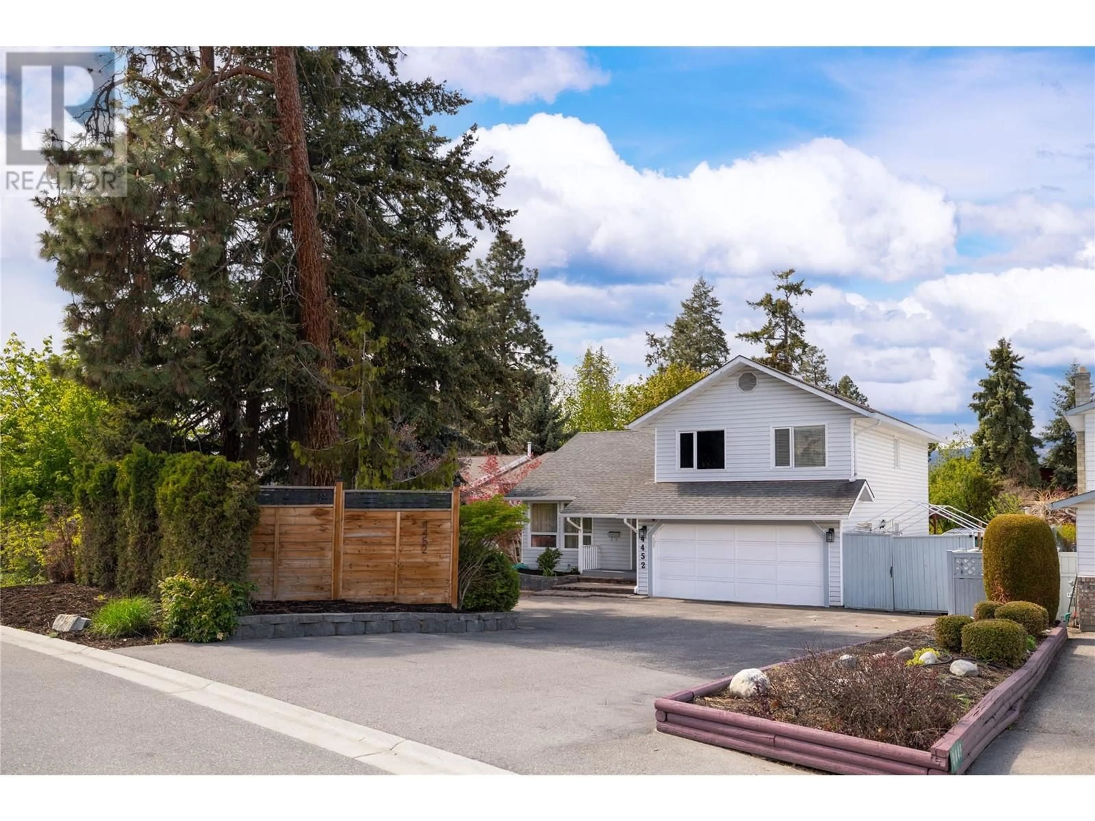 Frontside or backside of a home, the fenced backyard for 4452 Lakeshore Road, Kelowna British Columbia V1W1W8