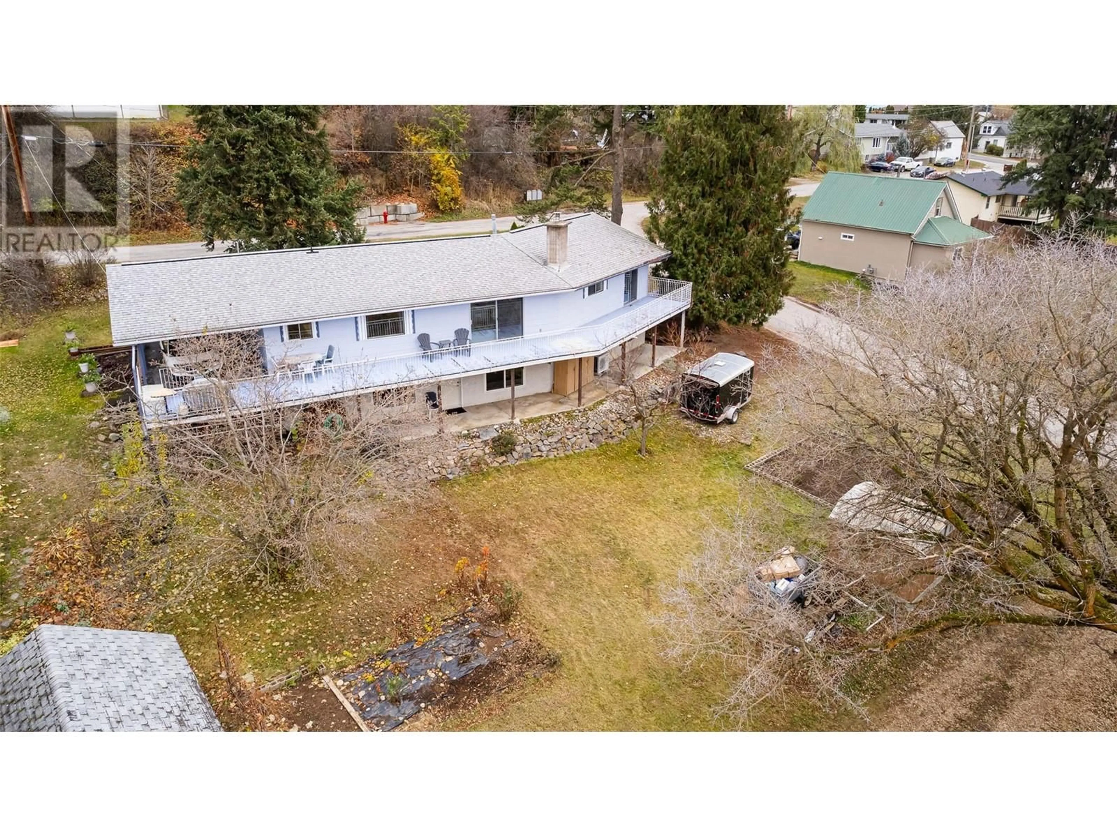 Frontside or backside of a home, the fenced backyard for 205 5th Avenue N, Creston British Columbia V0B1G3