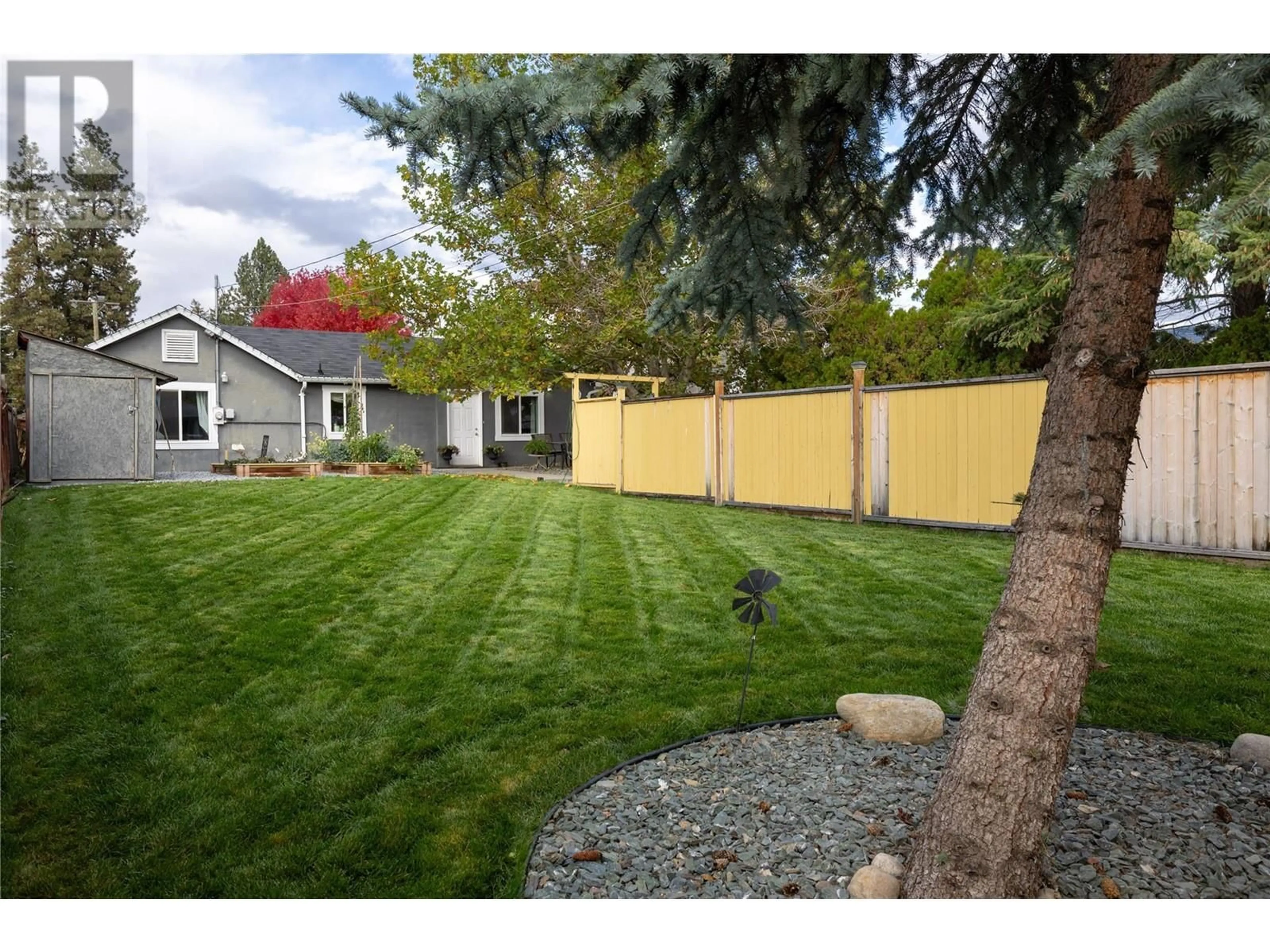 Frontside or backside of a home, the fenced backyard for 1905 46 Avenue, Vernon British Columbia V1T3P4