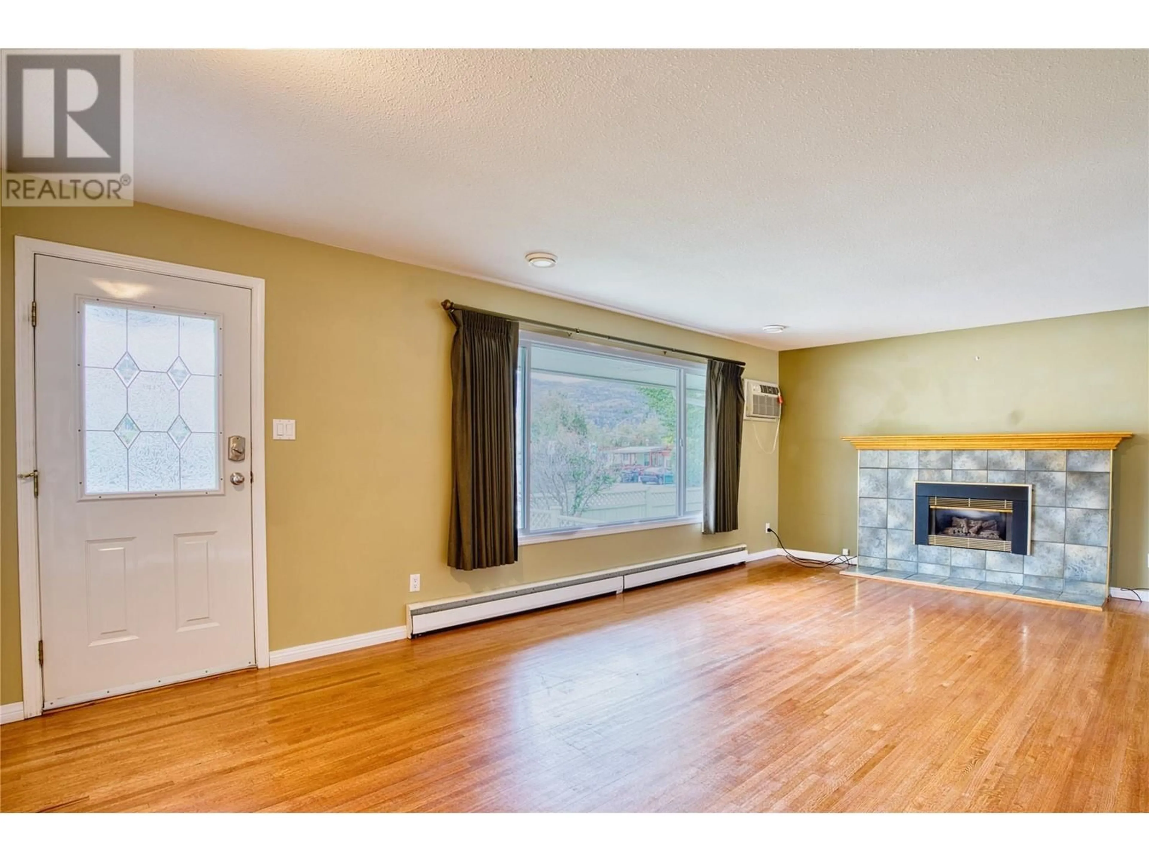 A pic of a room, wood floors for 1477 Atkinson Street, Penticton British Columbia V2A6B3