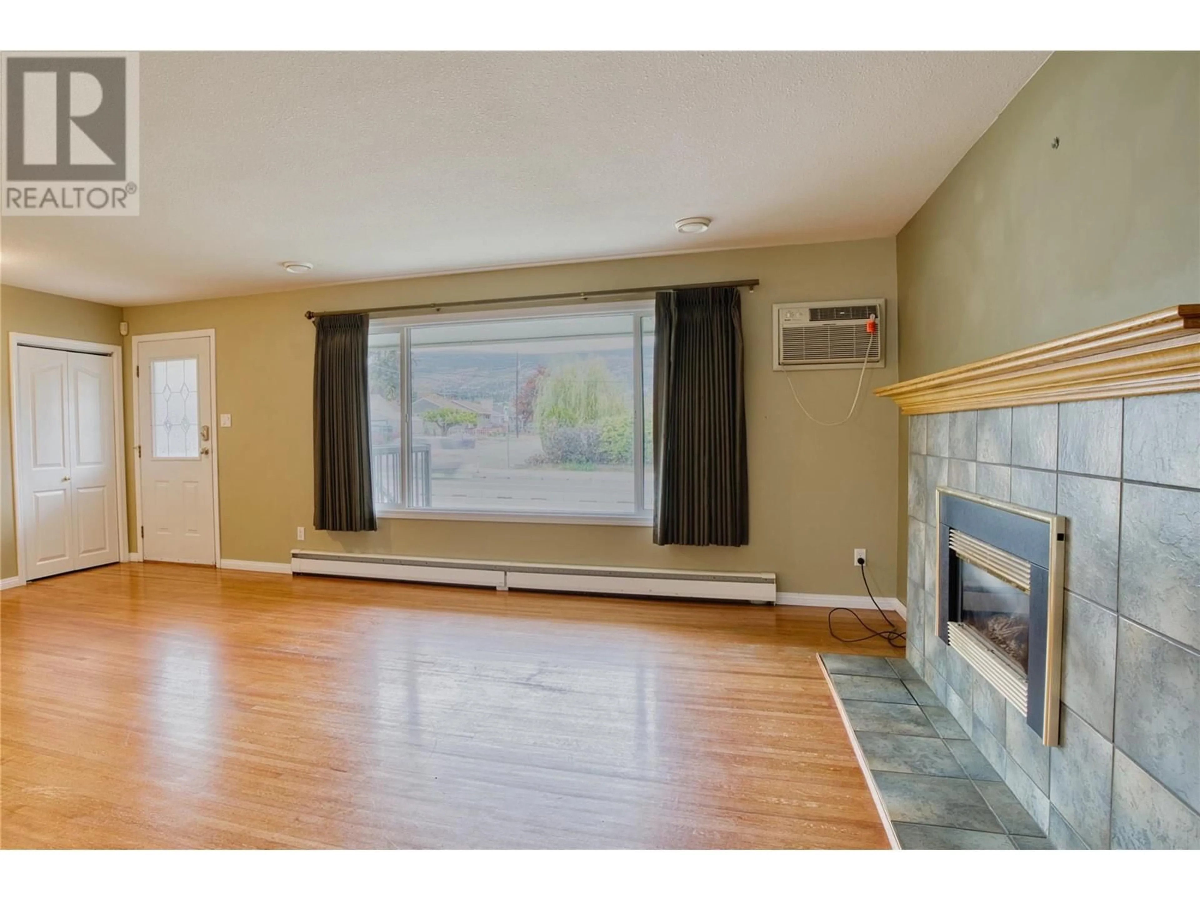 A pic of a room, wood floors for 1477 Atkinson Street, Penticton British Columbia V2A6B3