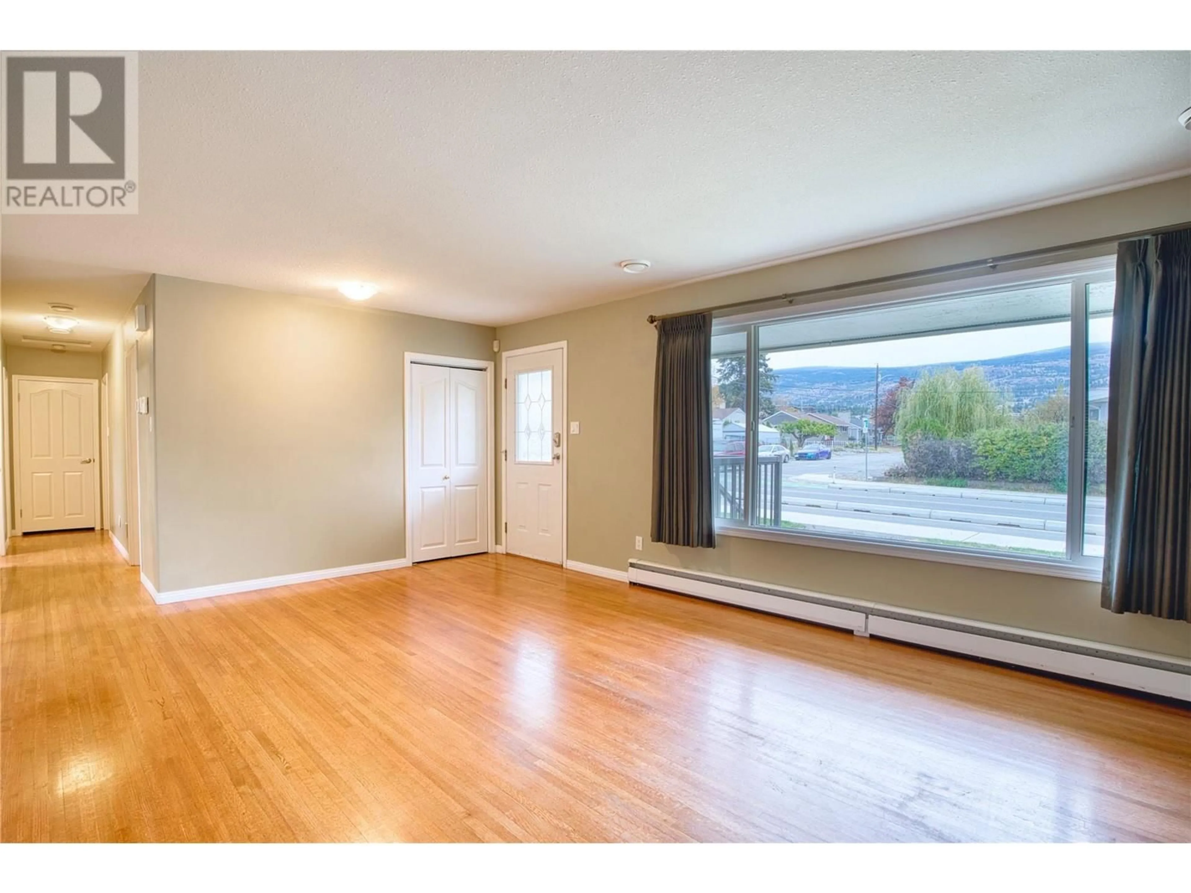 A pic of a room, wood floors for 1477 Atkinson Street, Penticton British Columbia V2A6B3