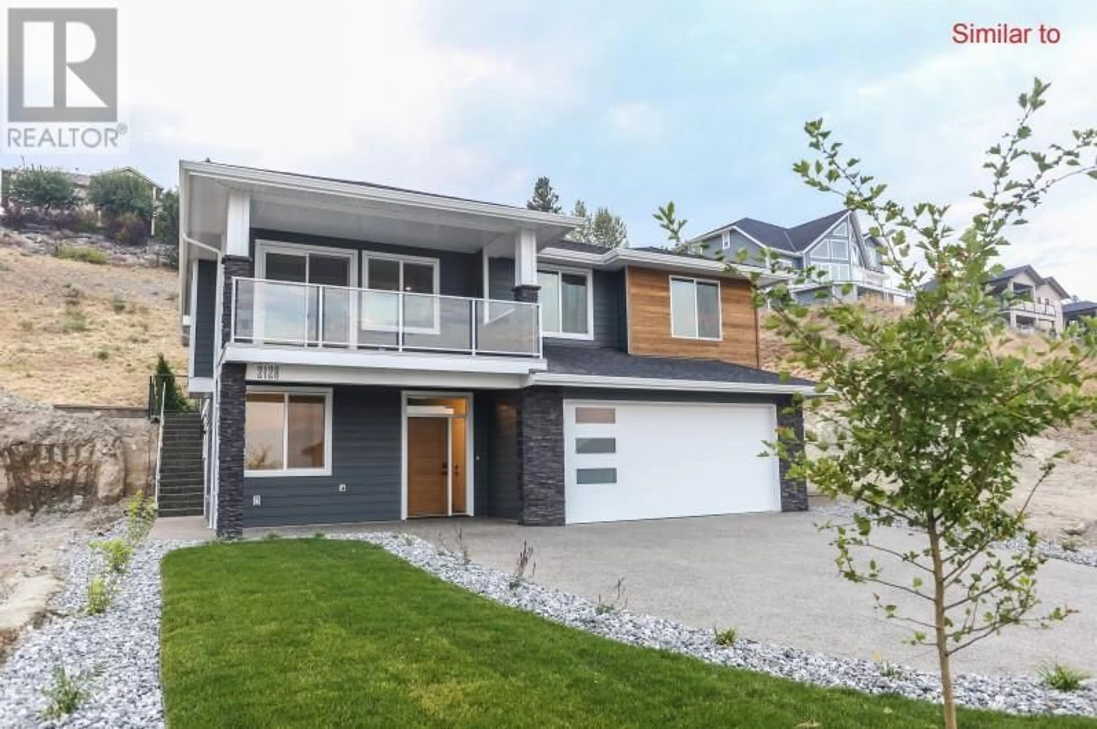 Home with vinyl exterior material, street for 7186 DUNWATERS ROAD, Kelowna British Columbia V1Z3W5