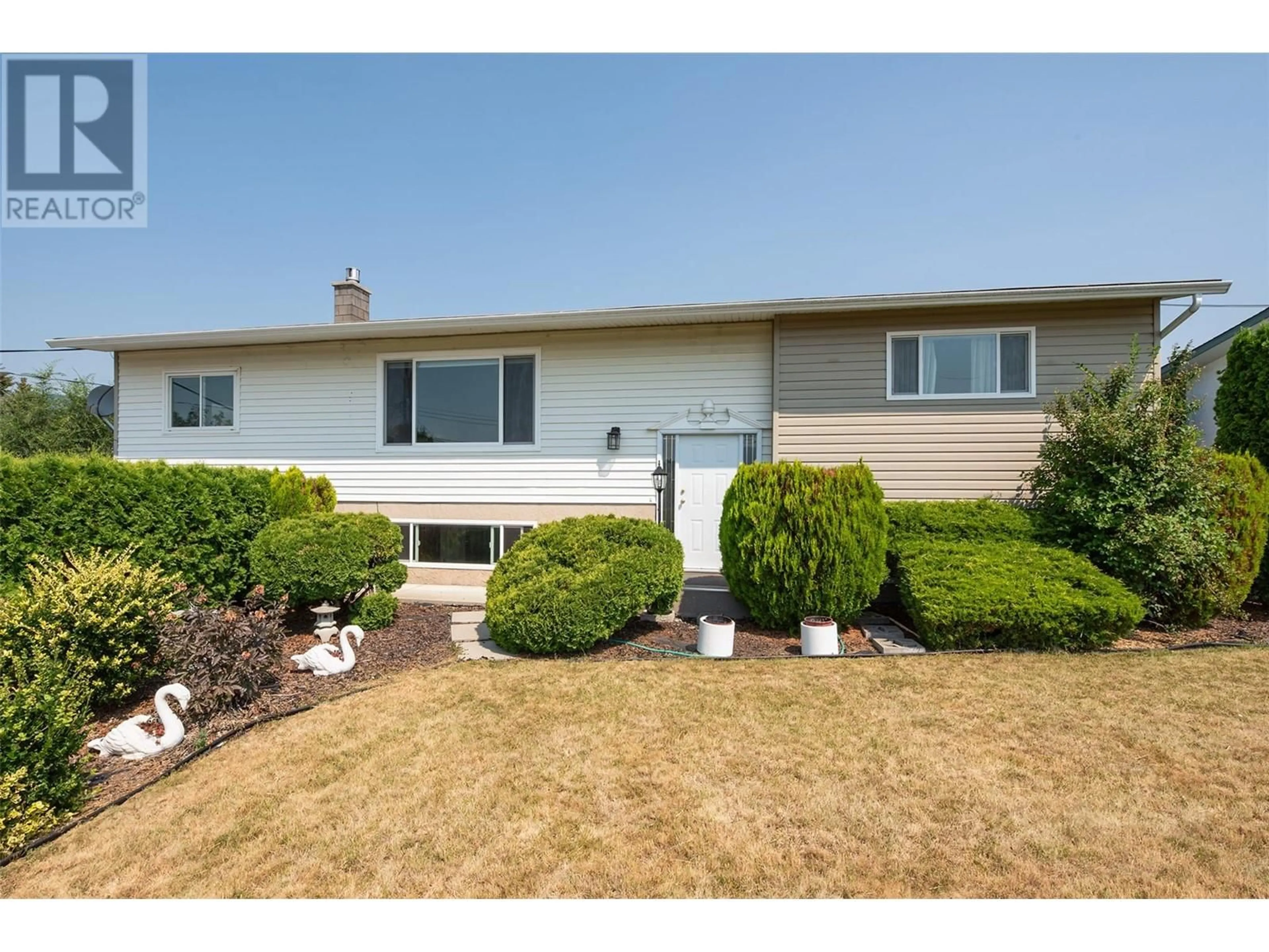 Frontside or backside of a home, the fenced backyard for 2472 Smid Road, West Kelowna British Columbia V4T1P1