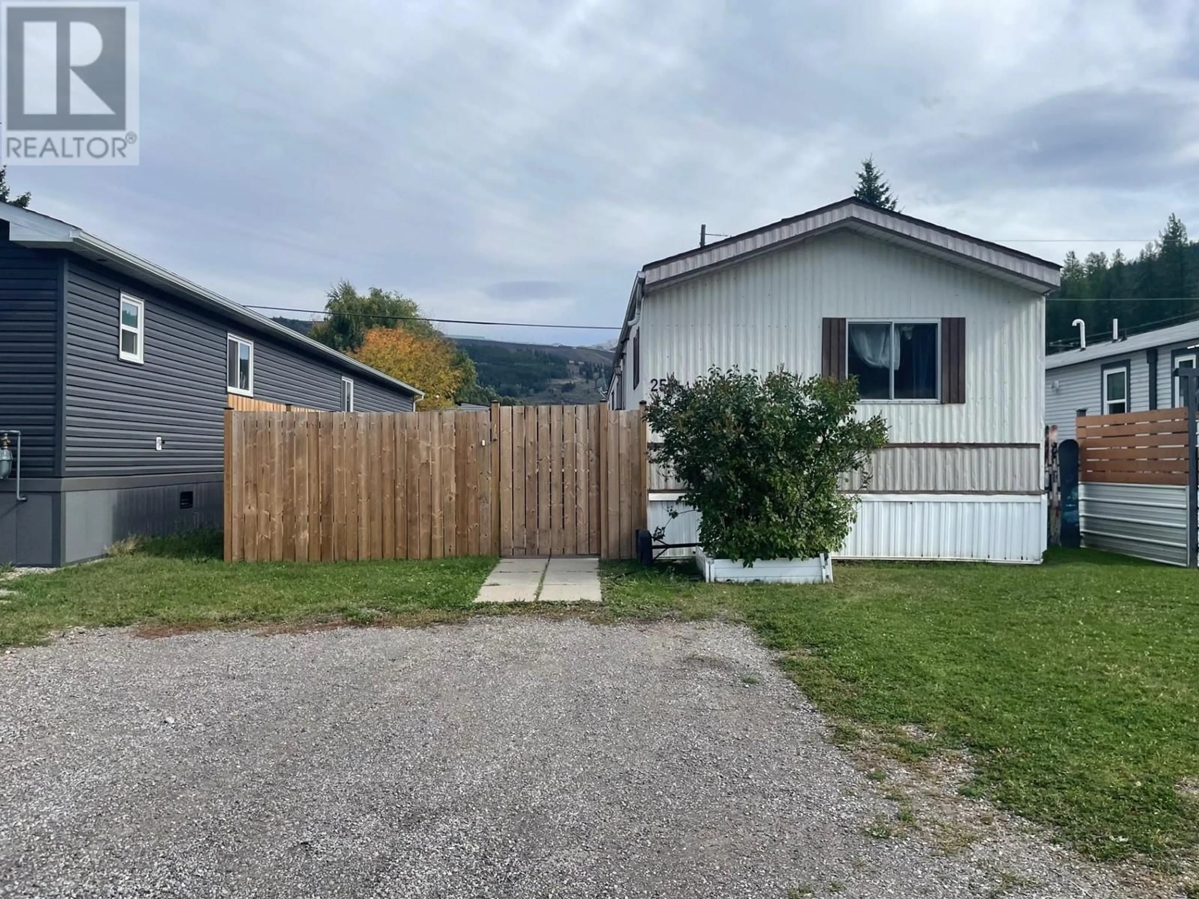 Frontside or backside of a home, the fenced backyard for 100 Aspen Drive Unit# 25, Sparwood British Columbia V0B2G0