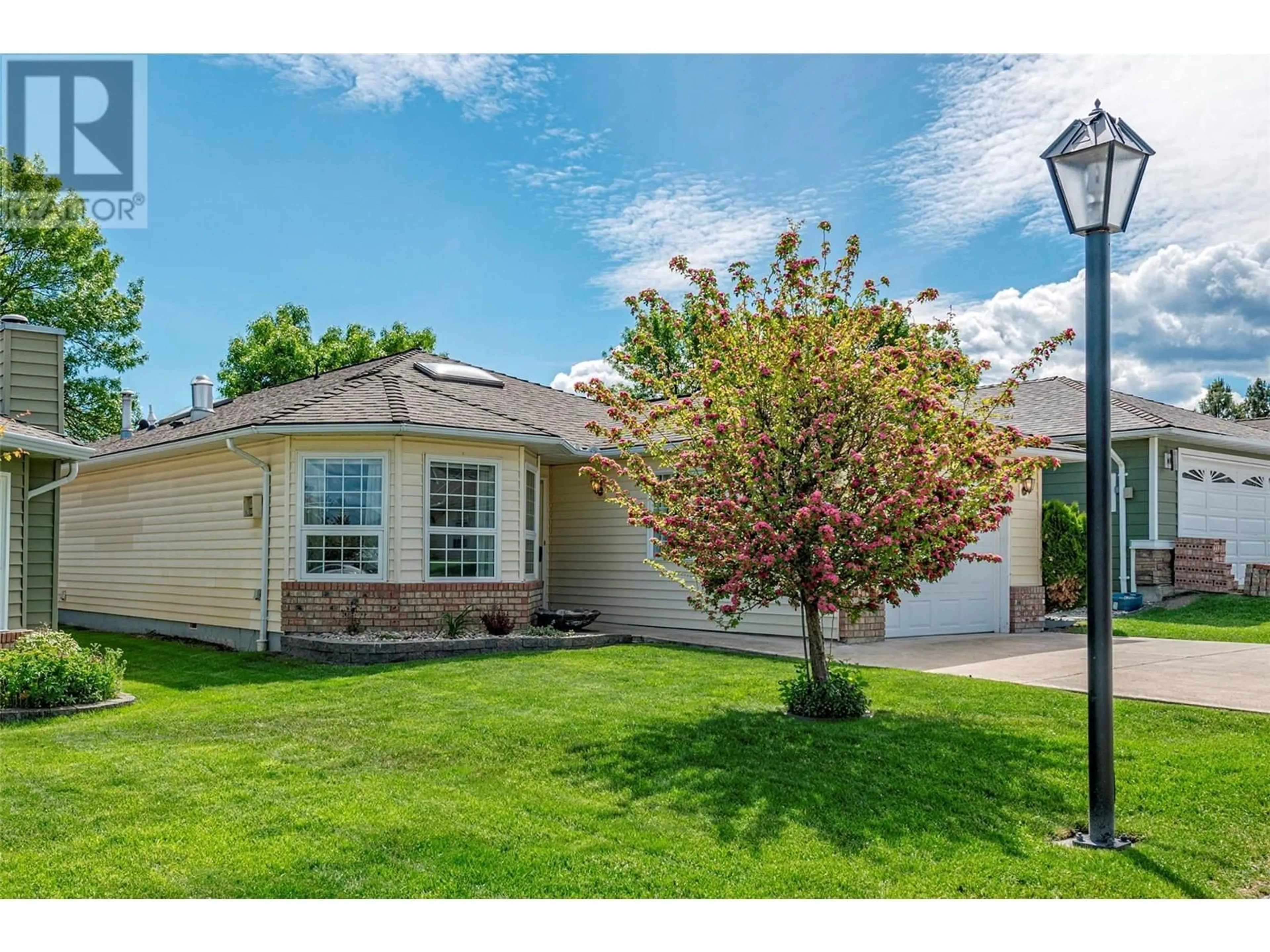 A pic from exterior of the house or condo, the fenced backyard for 1108 14 Avenue Unit# 134, Vernon British Columbia V1B2S5