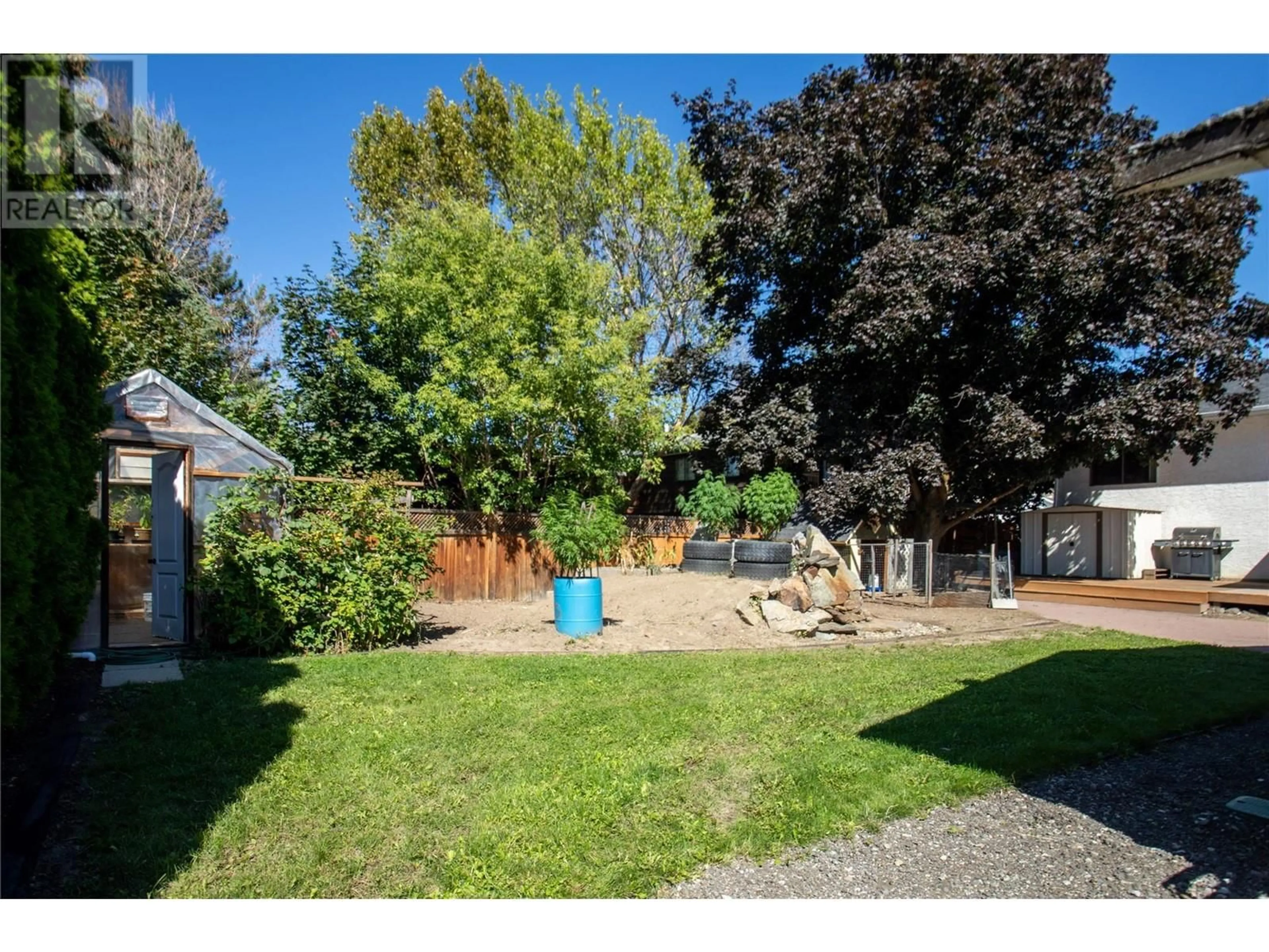 Frontside or backside of a home, the fenced backyard for 2140 Hadden Court, Kelowna British Columbia V1P1G8