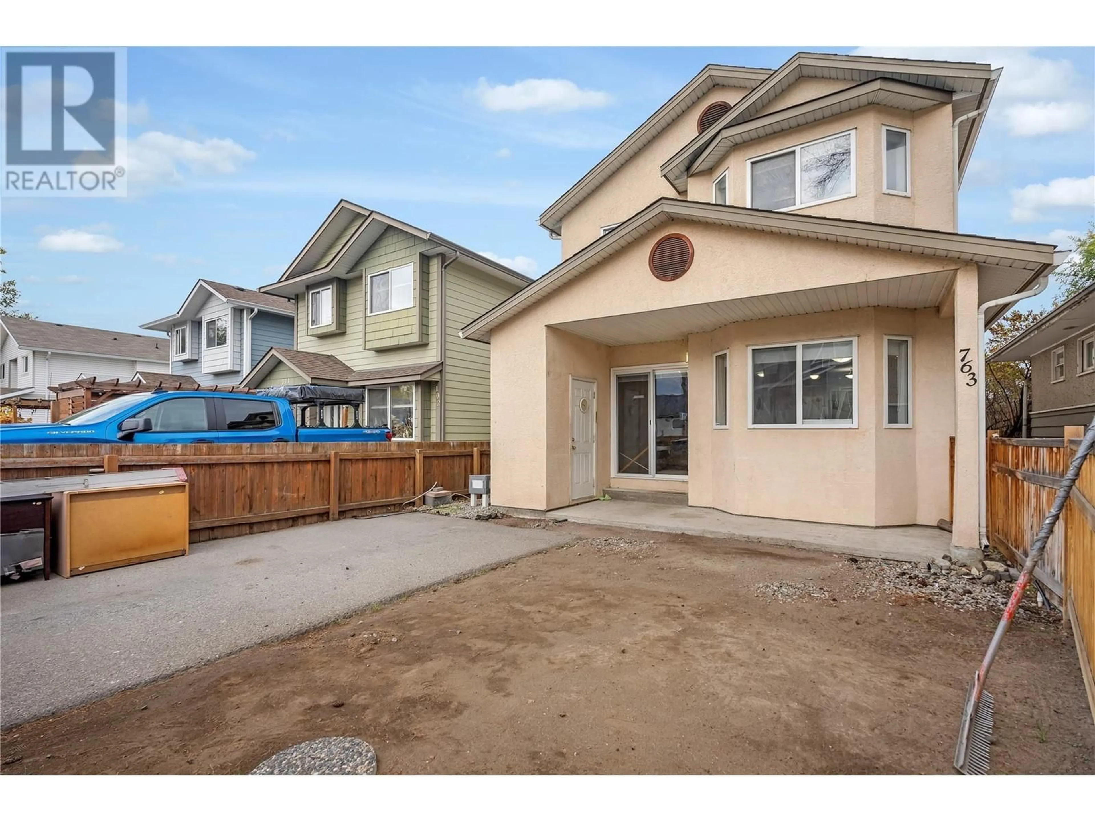 Frontside or backside of a home, the fenced backyard for 763 Kamloops Avenue Unit# 101, Penticton British Columbia V2A2J3