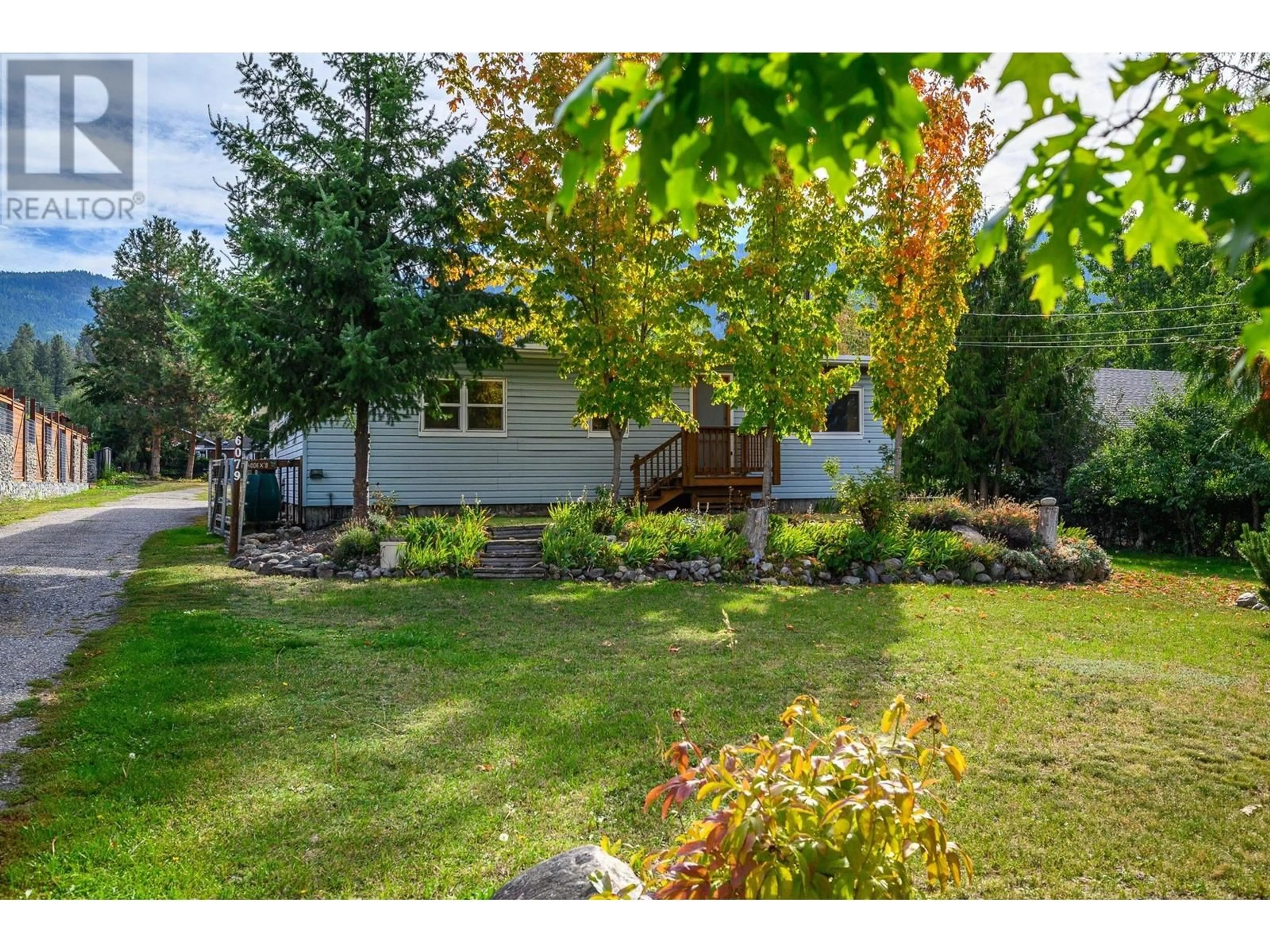 Frontside or backside of a home, the fenced backyard for 6079 Silver Star Road, Vernon British Columbia V1B3P3