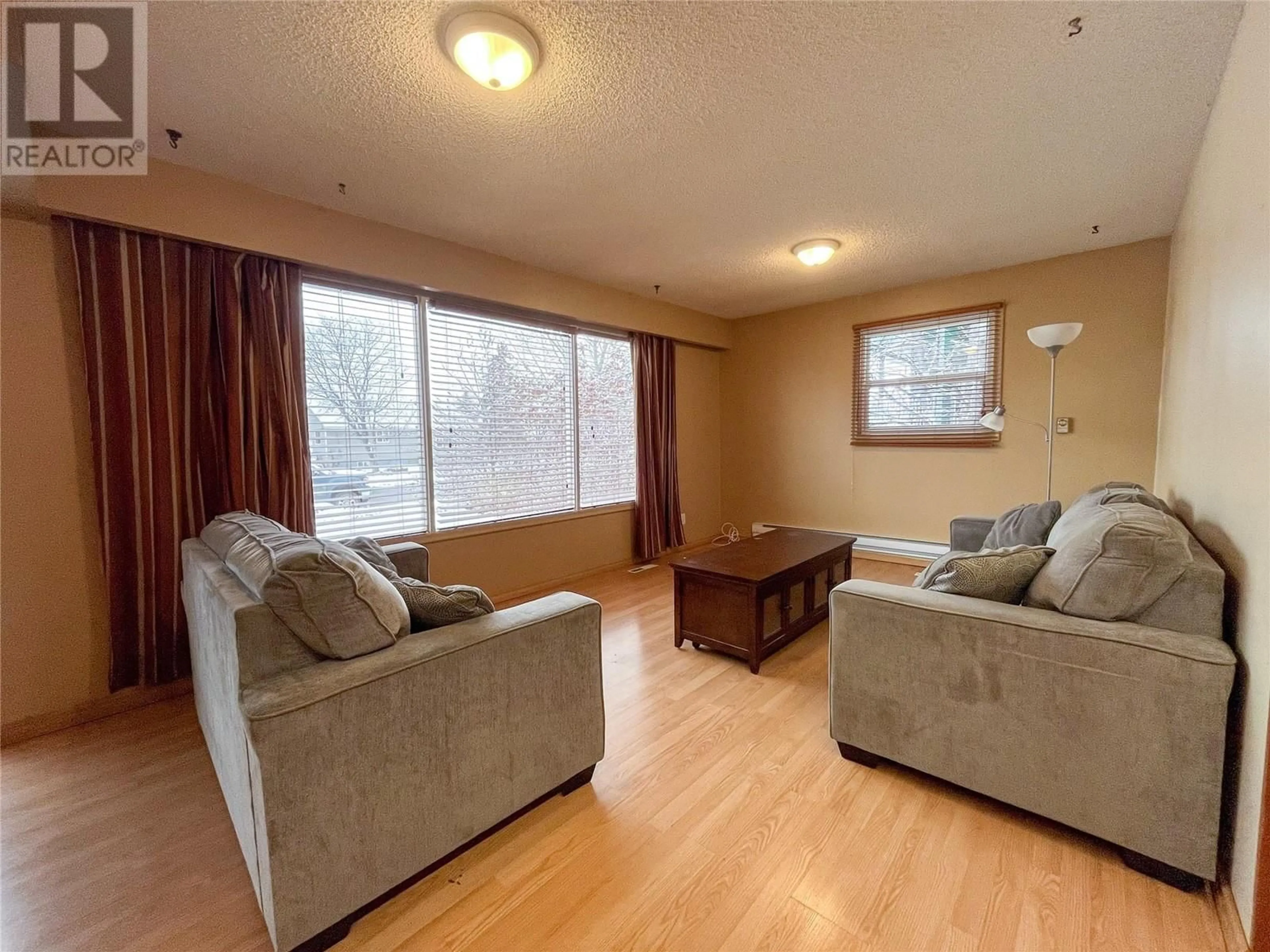 Living room with furniture, wood/laminate floor for 9204 9 STREET, Dawson Creek British Columbia V1G3S2