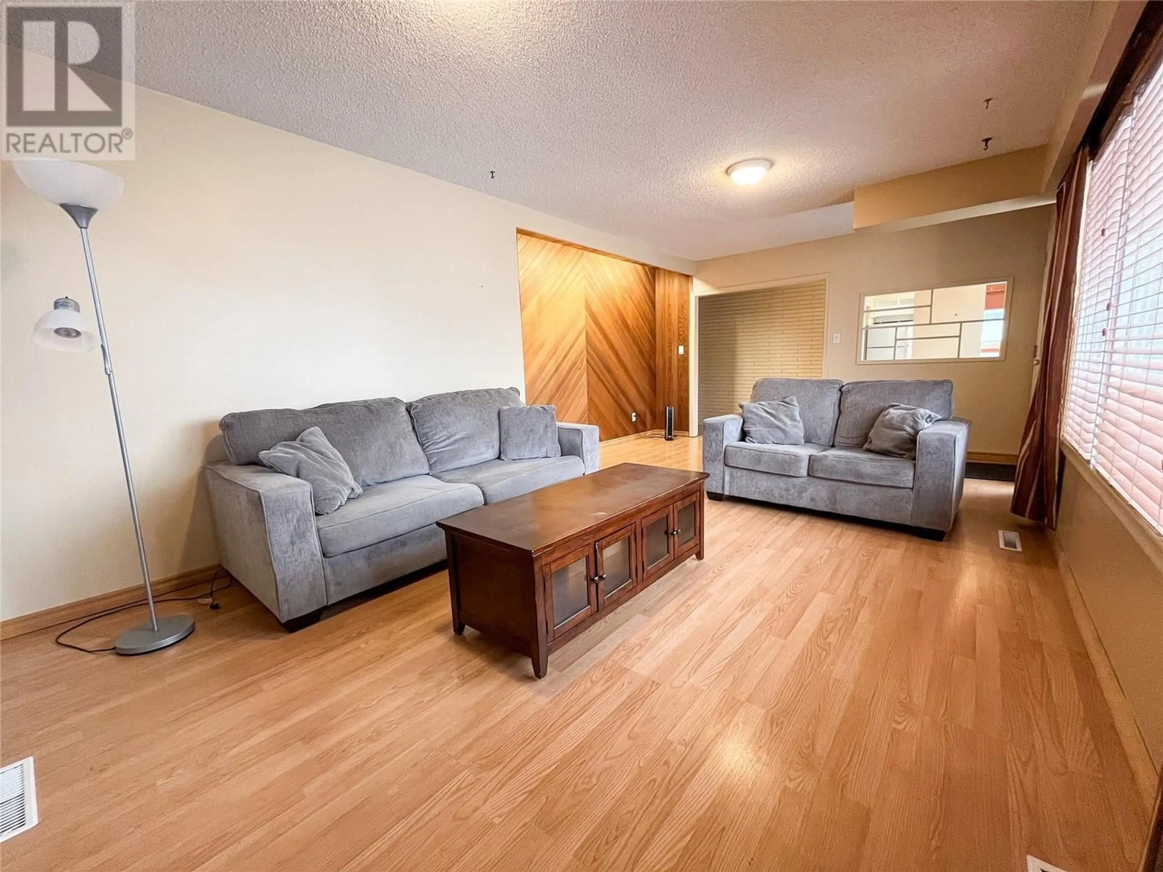 Living room with furniture, wood/laminate floor for 9204 9 STREET, Dawson Creek British Columbia V1G3S2
