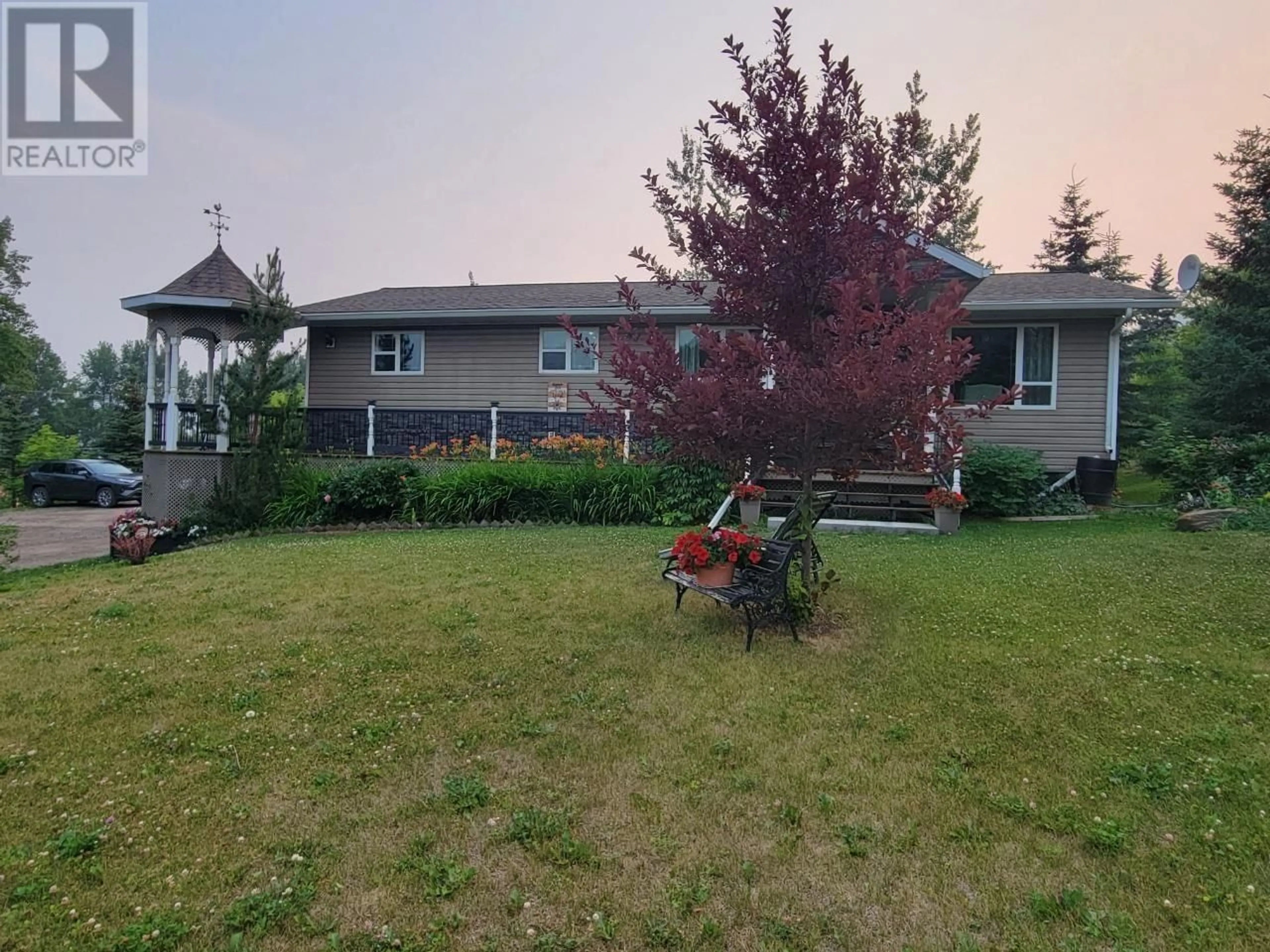 Frontside or backside of a home, the fenced backyard for 5933 KURJATA Road, Chetwynd British Columbia V0C1J0