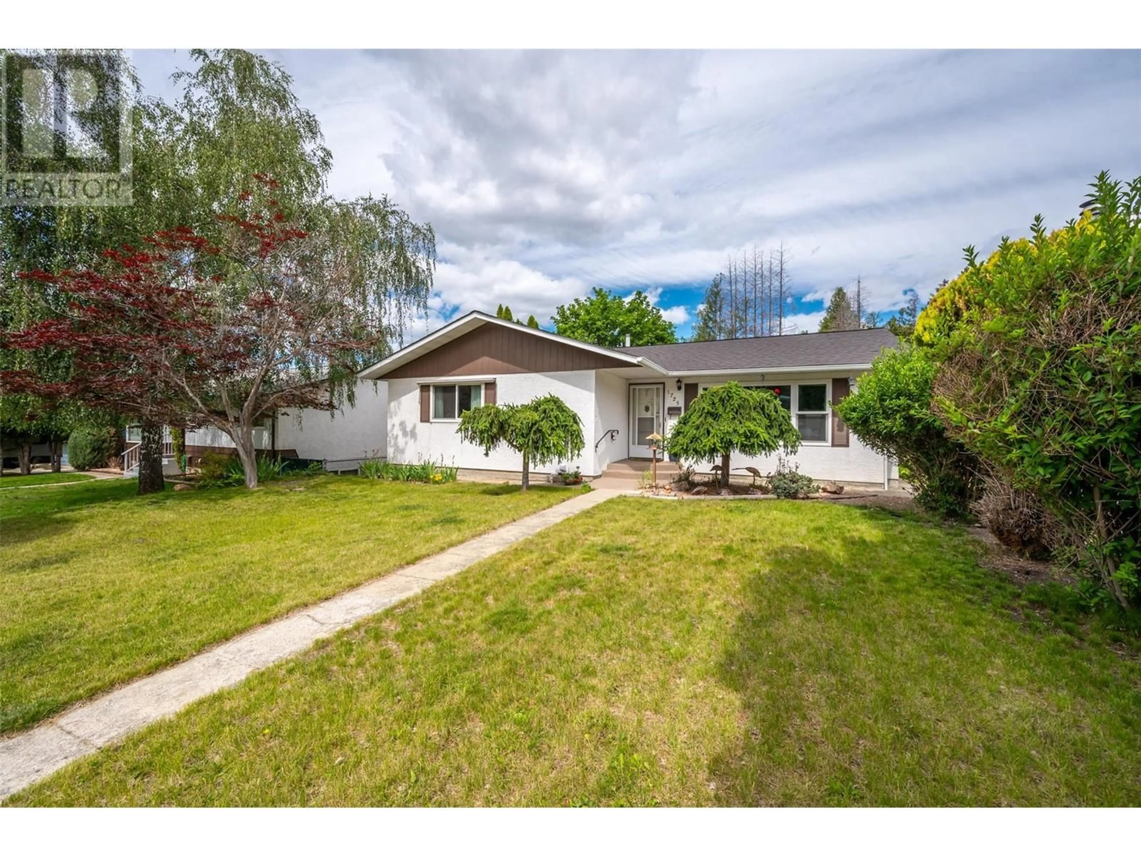 Frontside or backside of a home, the fenced backyard for 1725 Duncan Avenue E, Penticton British Columbia V2A7C3