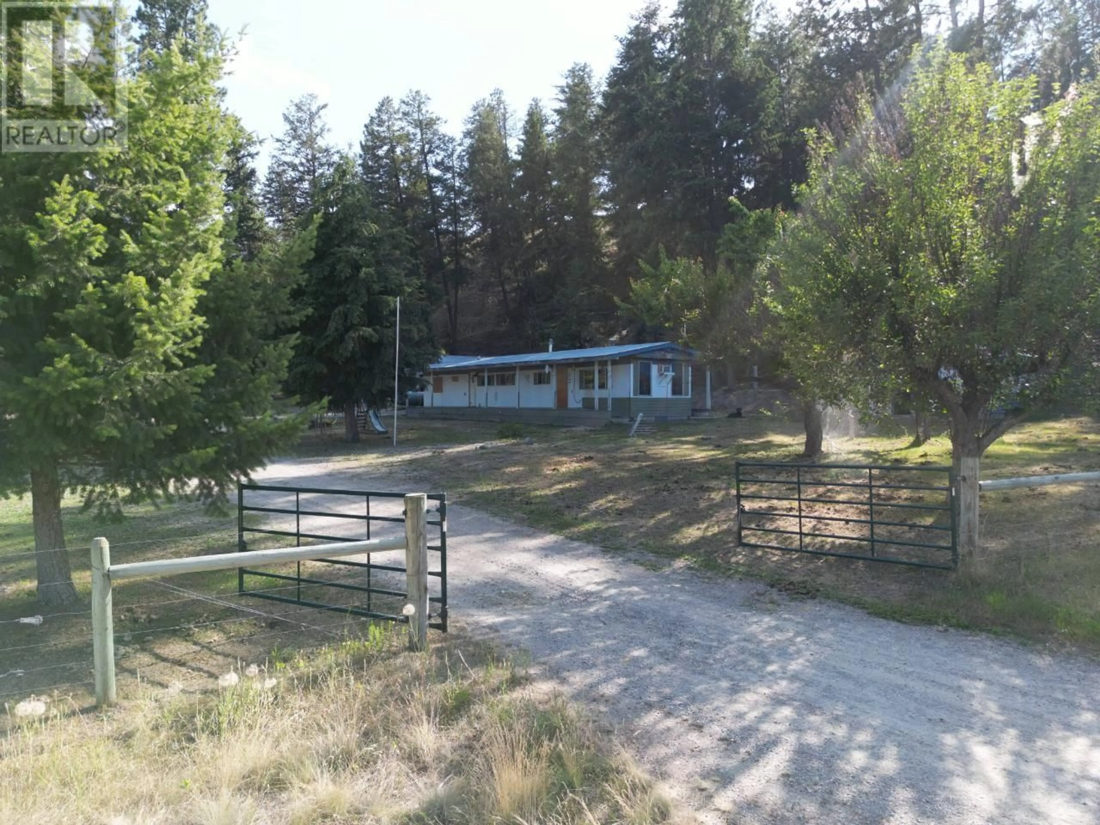 Frontside or backside of a home, the fenced backyard for 4160 Highway 3 Highway, Rock Creek British Columbia V0H1Y0