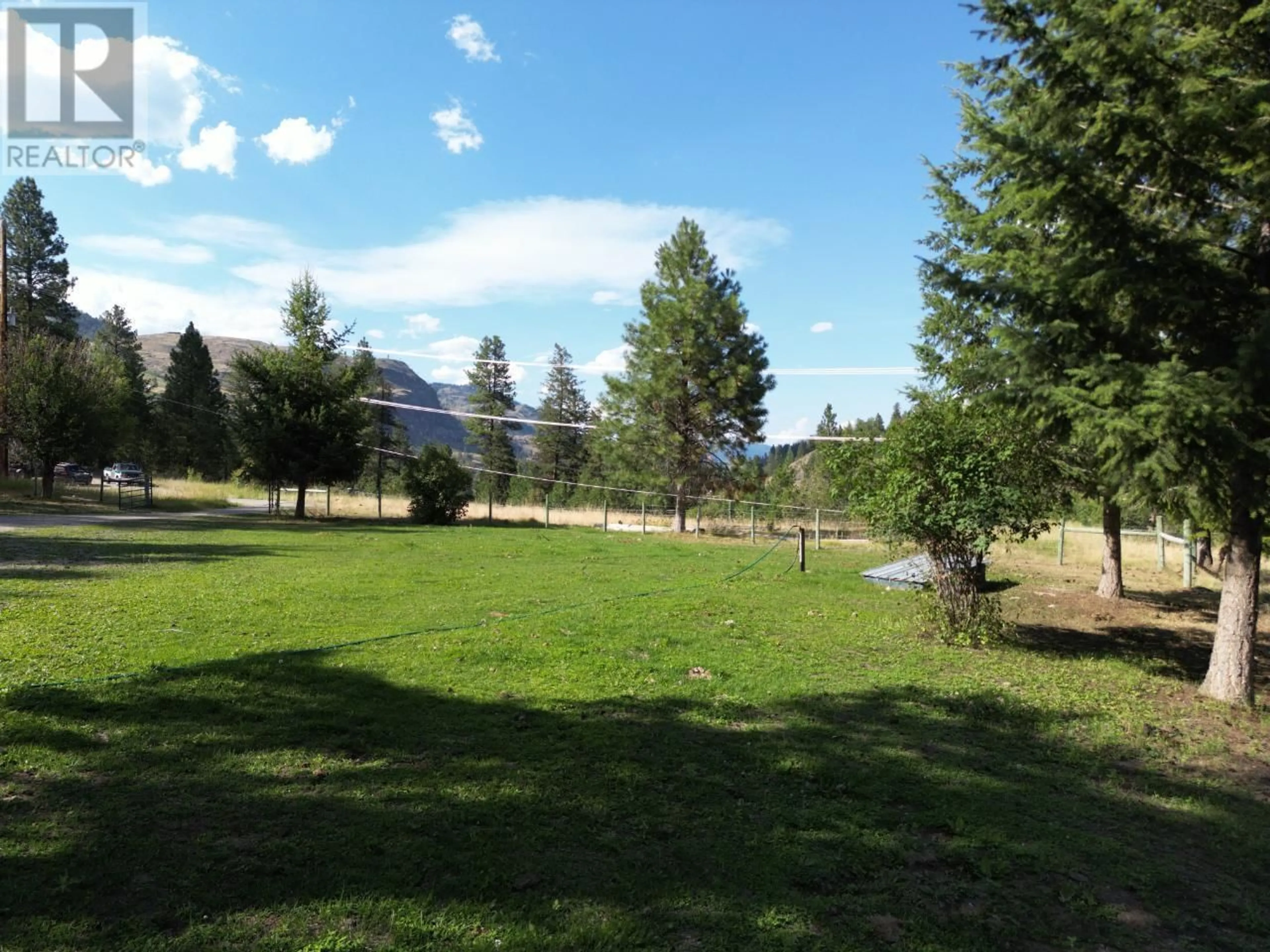 A pic from exterior of the house or condo, the fenced backyard for 4160 Highway 3 Highway, Rock Creek British Columbia V0H1Y0