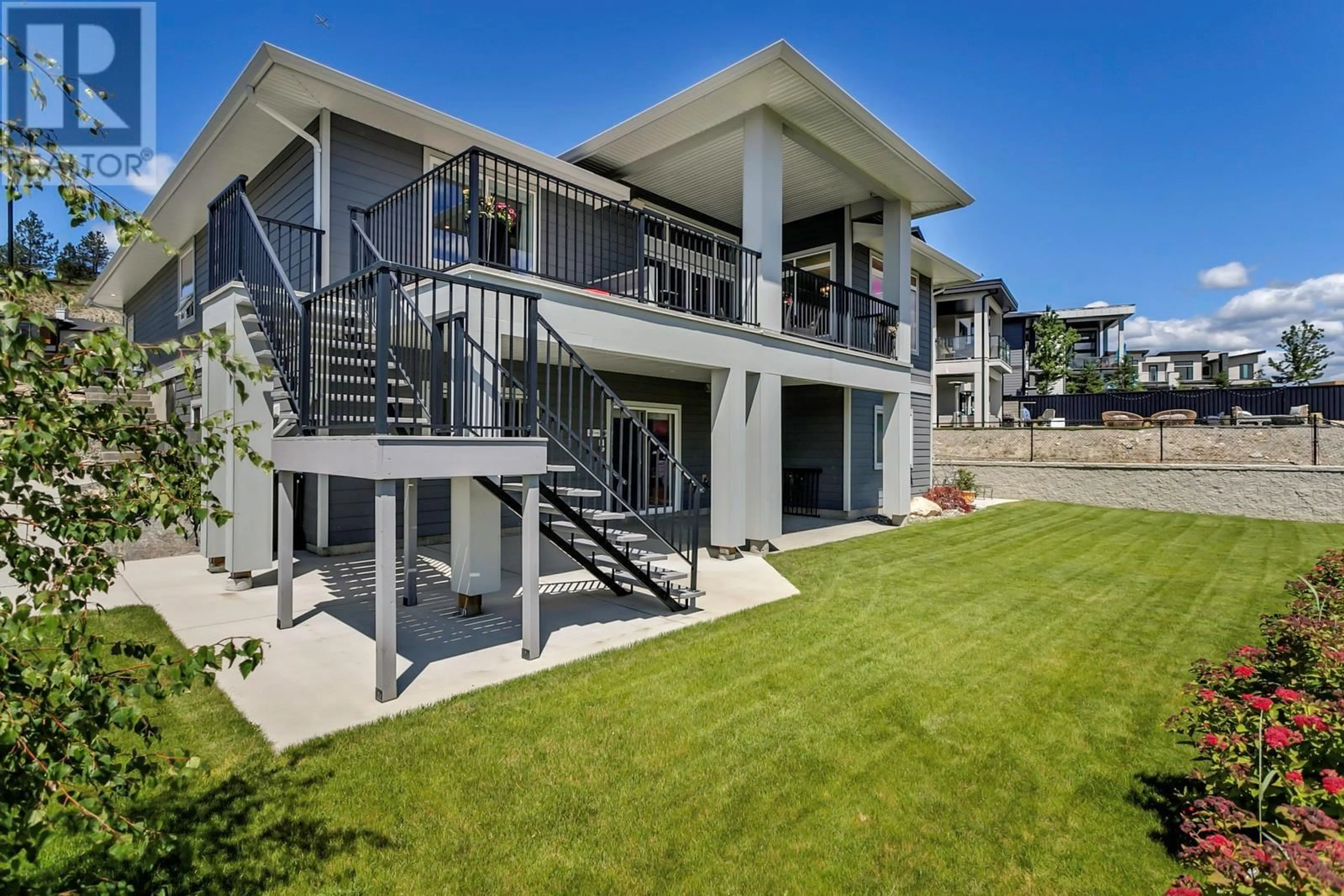 A pic from exterior of the house or condo, the fenced backyard for 1077 Loseth Drive, Kelowna British Columbia V1P0A1