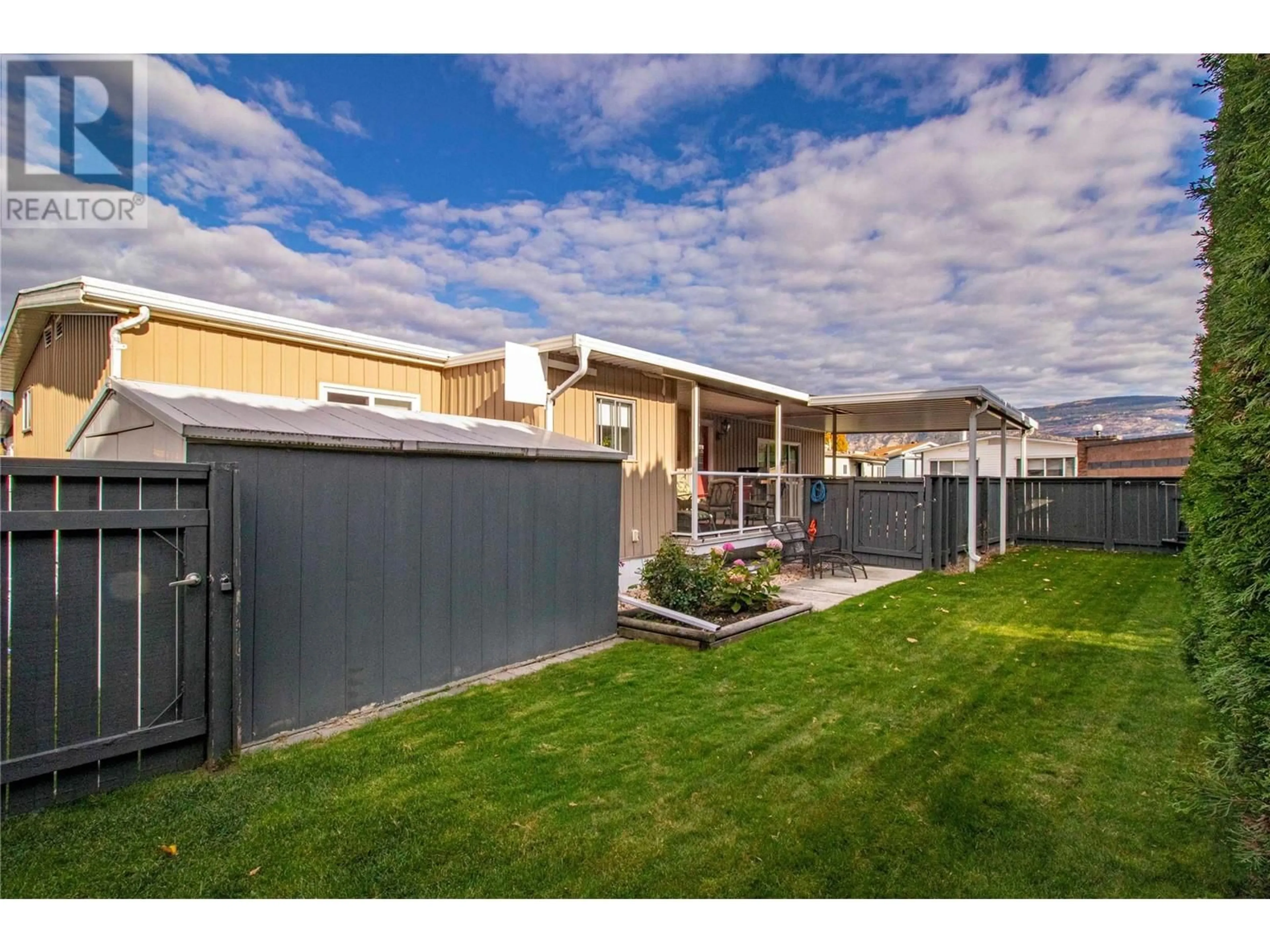 Frontside or backside of a home, the fenced backyard for 999 Burnaby Avenue Unit# 17, Penticton British Columbia V2A1G7