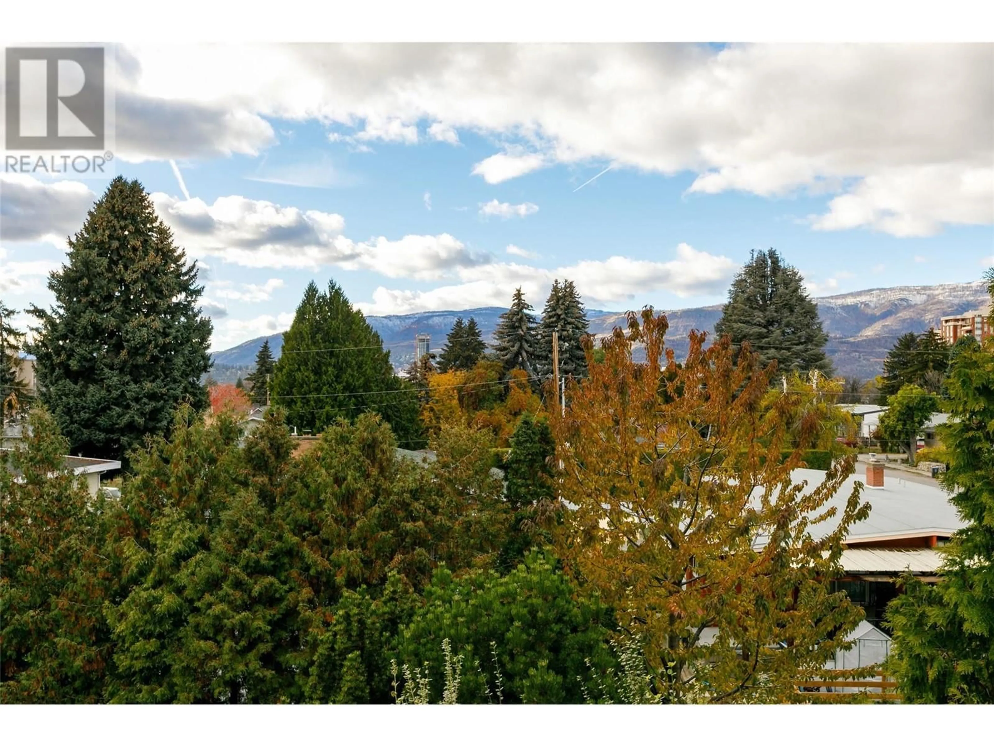 A pic from exterior of the house or condo, the fenced backyard for 1674 Thayer Court, Kelowna British Columbia V1Y8M2