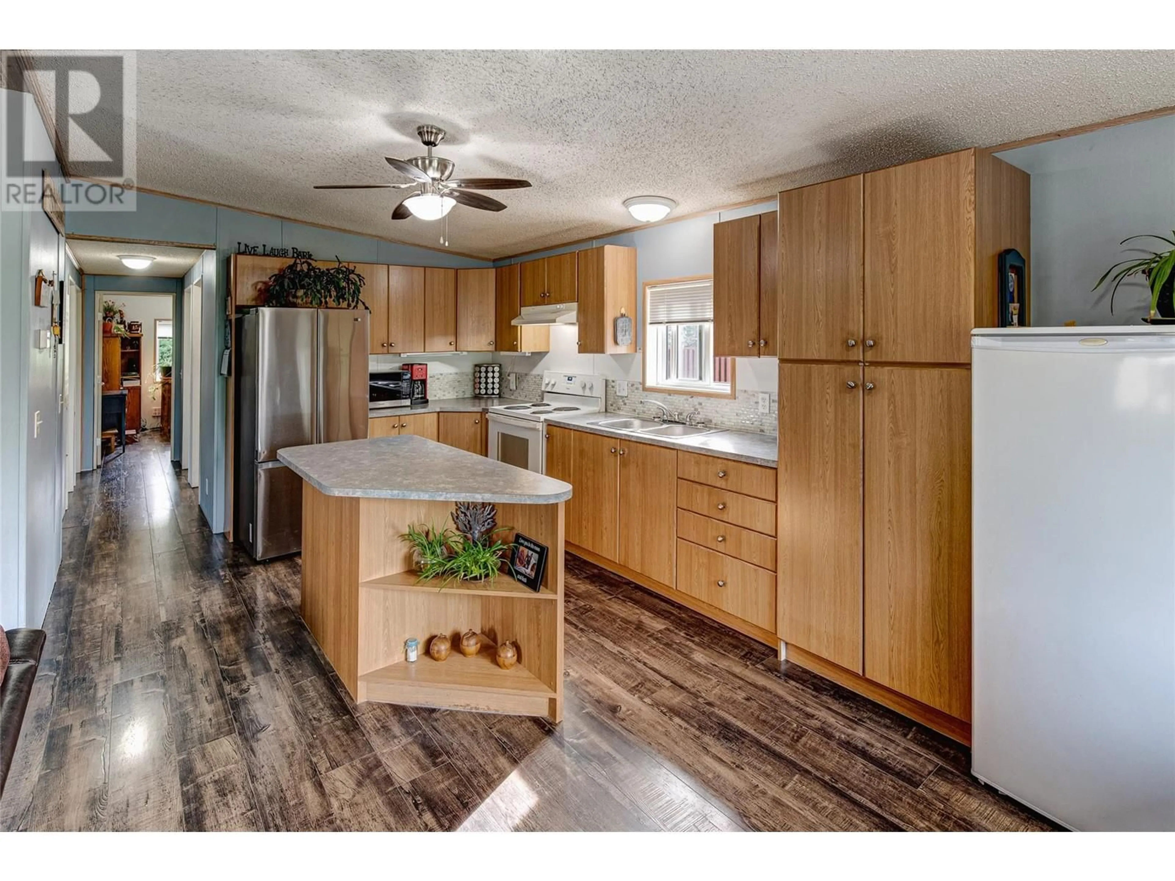 Open concept kitchen, wood/laminate floor for 102 - 5155 CHUTE LAKE ROAD, Kelowna British Columbia V1W4R9