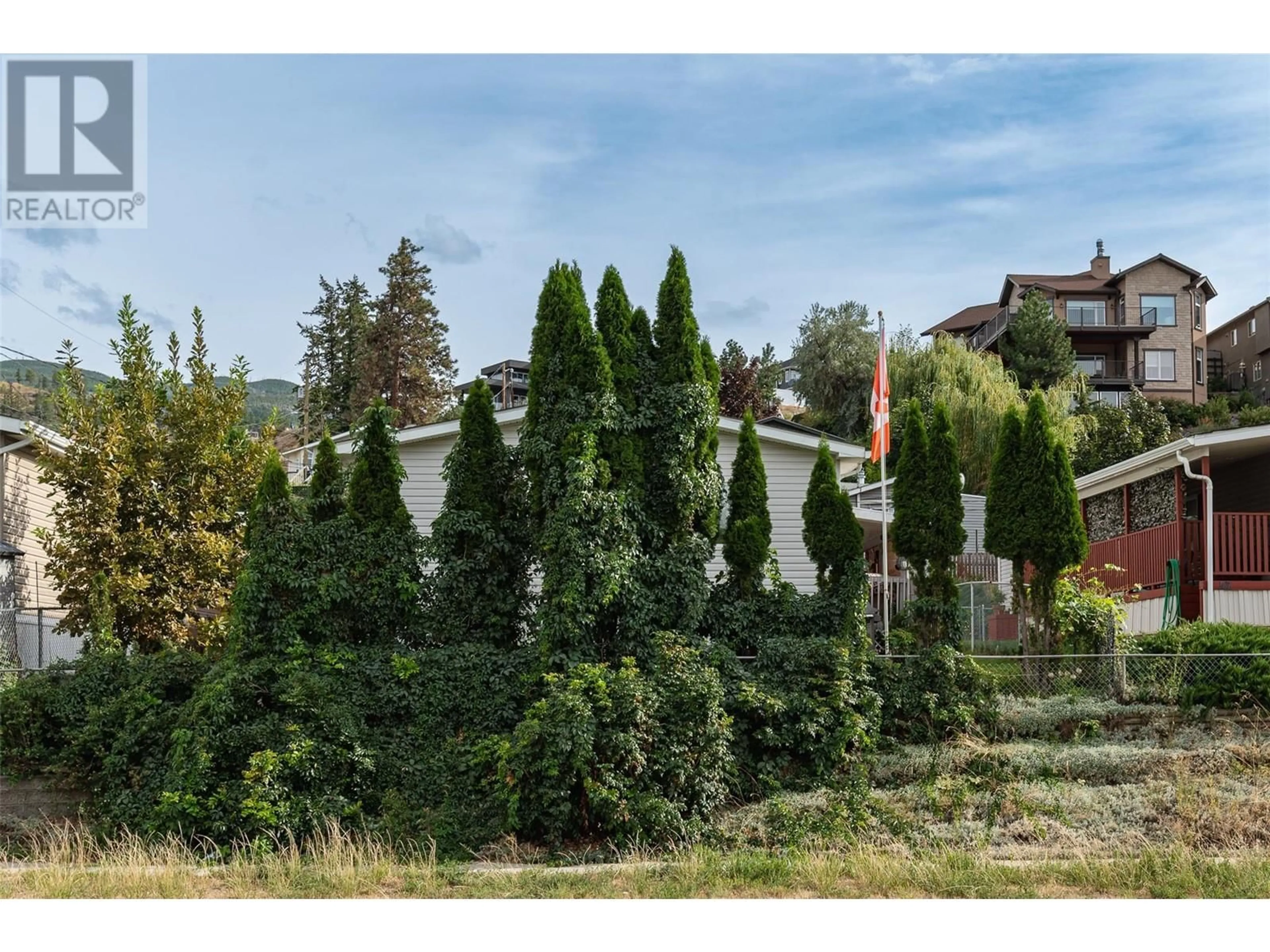 A pic from exterior of the house or condo, the fenced backyard for 5155 Chute Lake Road Unit# 102, Kelowna British Columbia V1W4R9