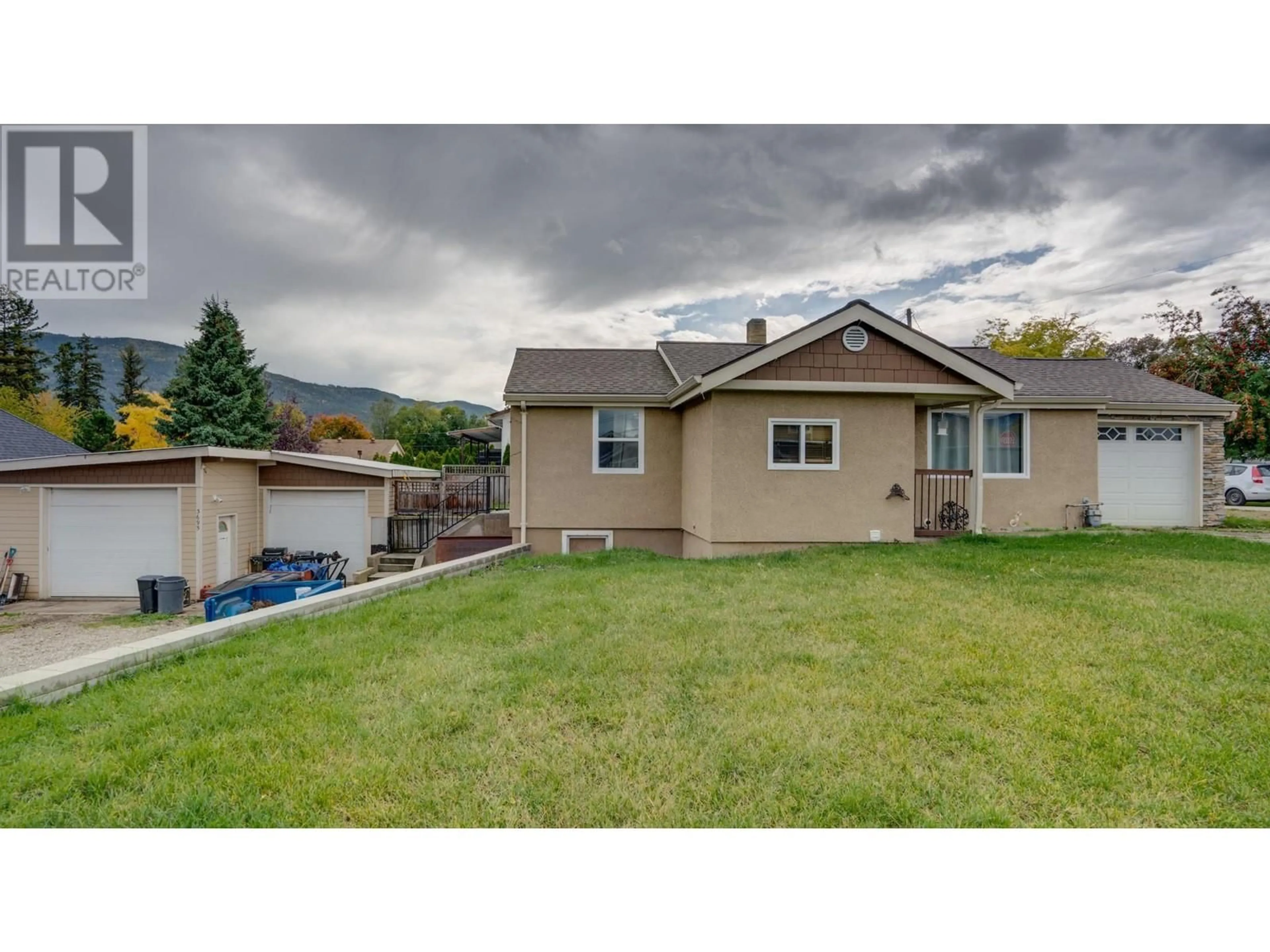 Frontside or backside of a home, the fenced backyard for 3695 Sage Avenue, Armstrong British Columbia V0E1B2