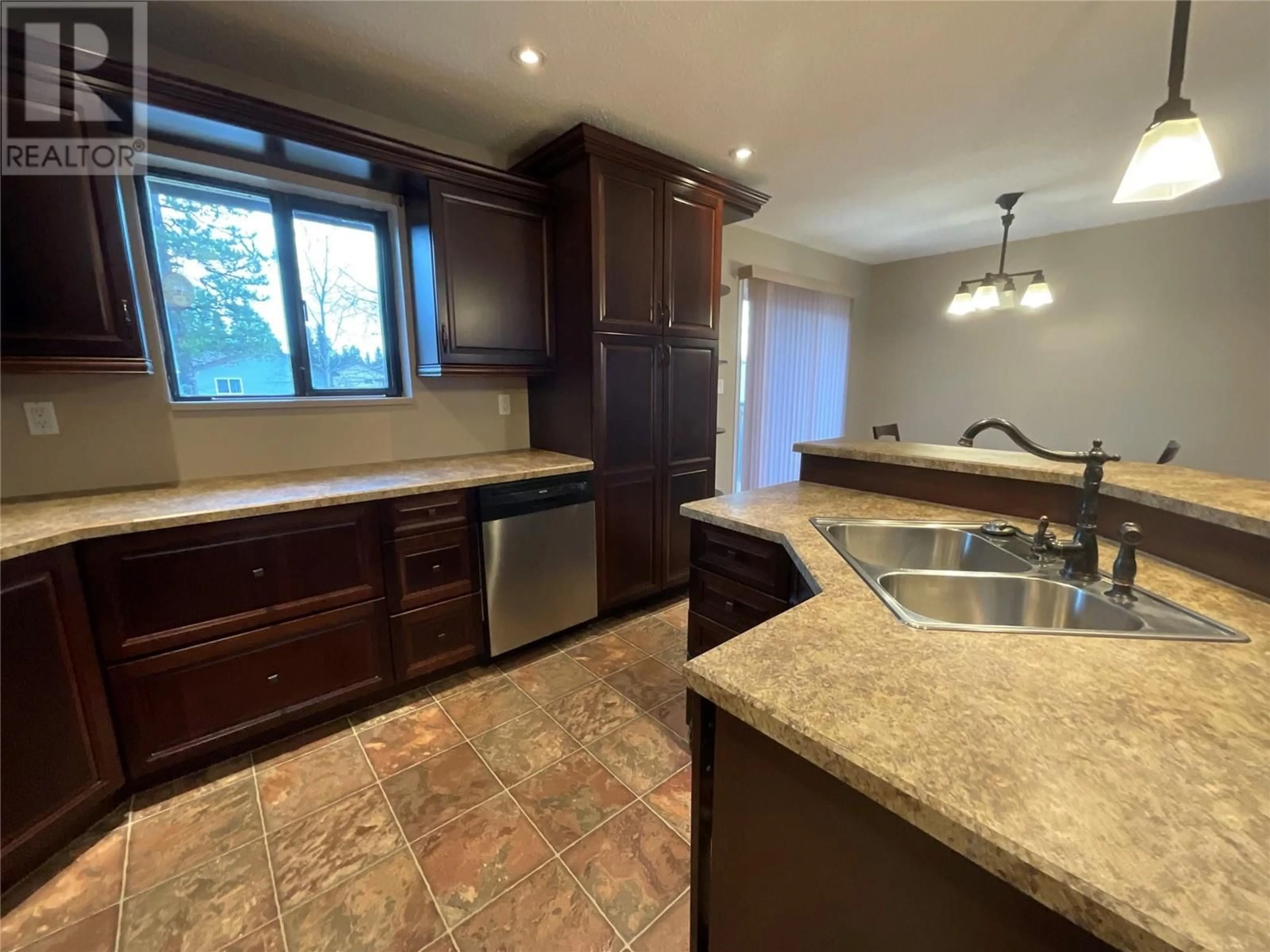 Open concept kitchen for 208 Willow Drive, Tumbler Ridge British Columbia V0C2W0