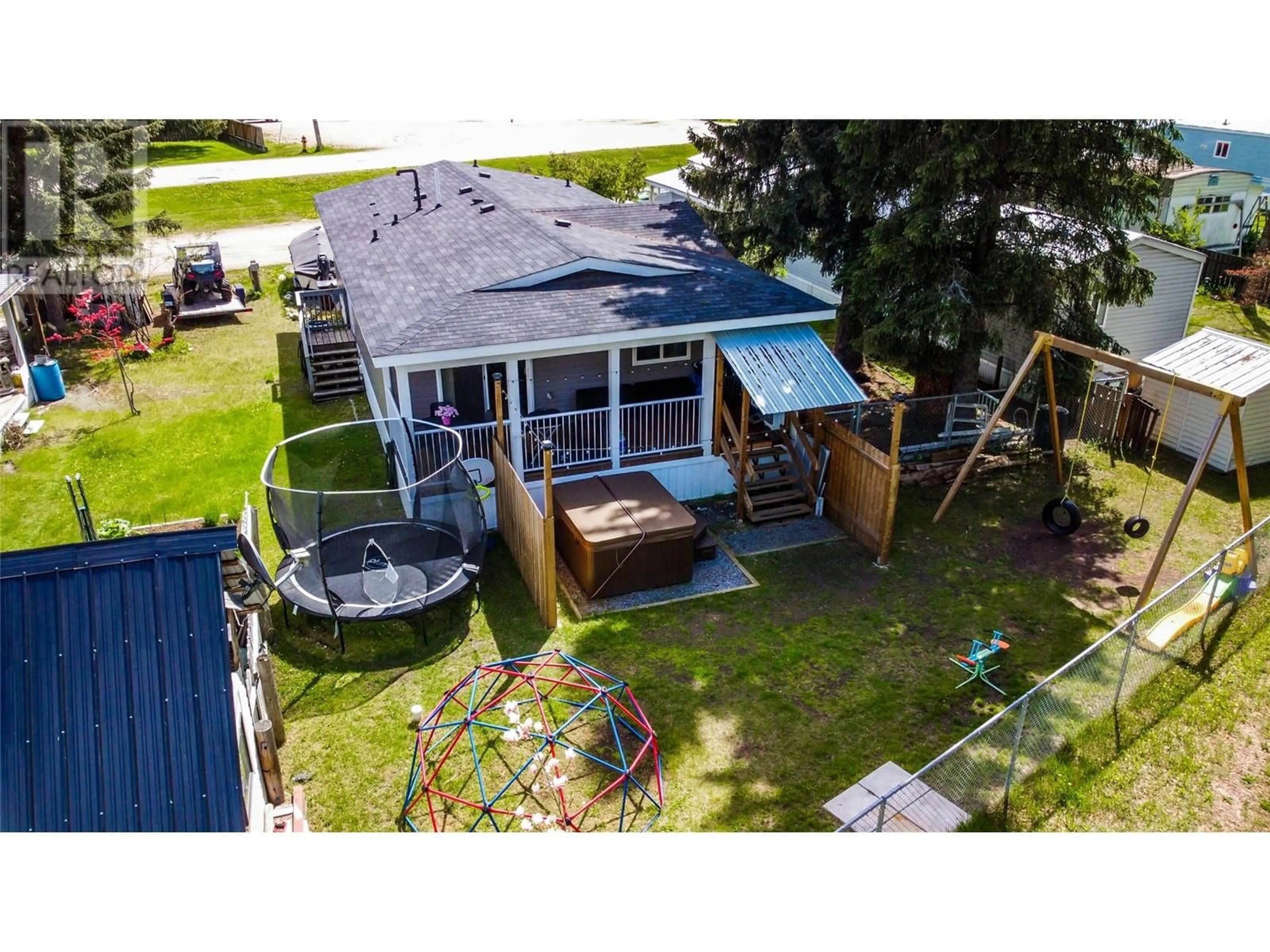 Frontside or backside of a home, the fenced backyard for 1442 Illecillewaet Road Unit# 5, Revelstoke British Columbia V0E2S0