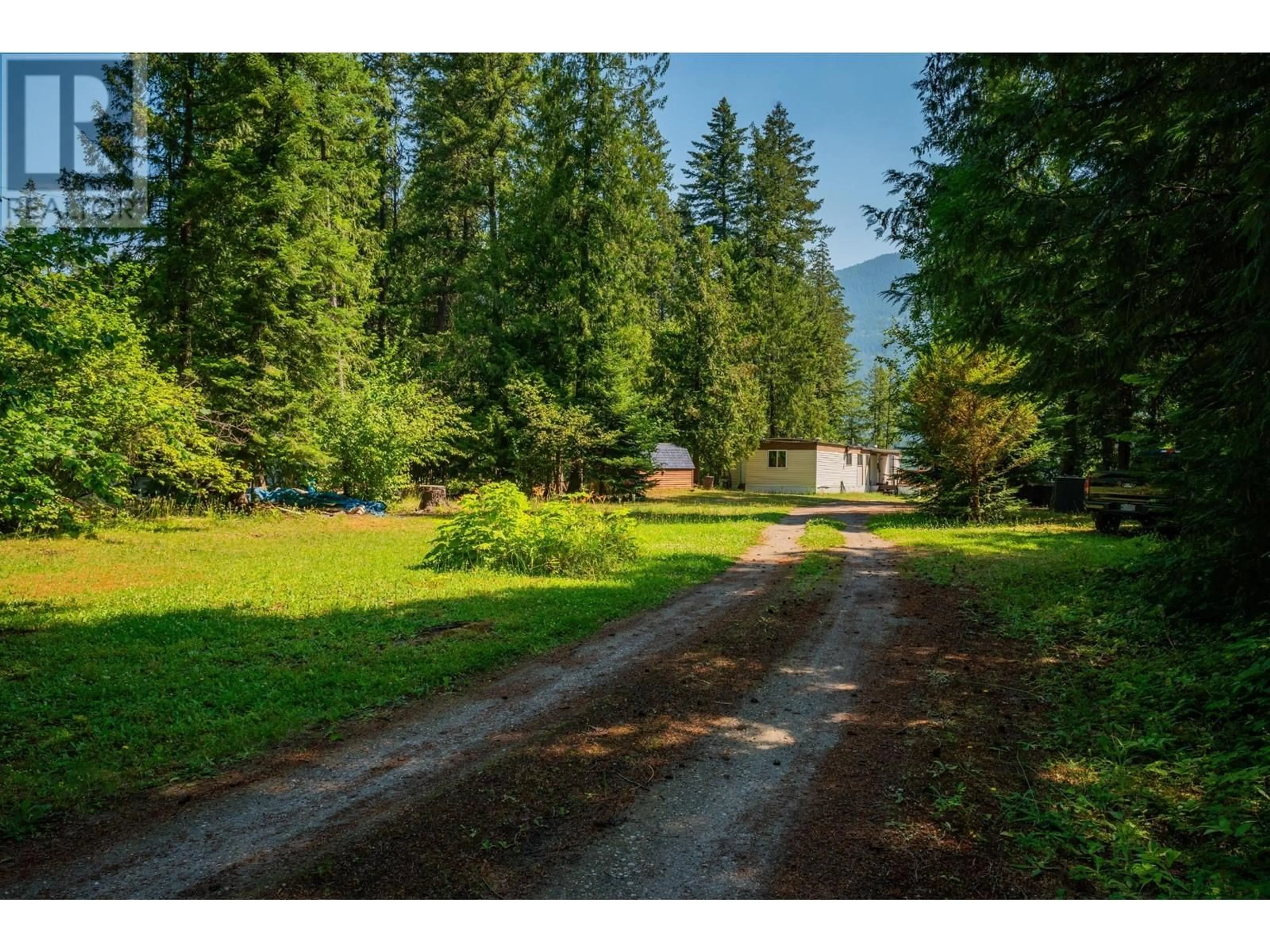 Frontside or backside of a home, the fenced backyard for 2048 3A Highway, Tarrys British Columbia V1N4N1