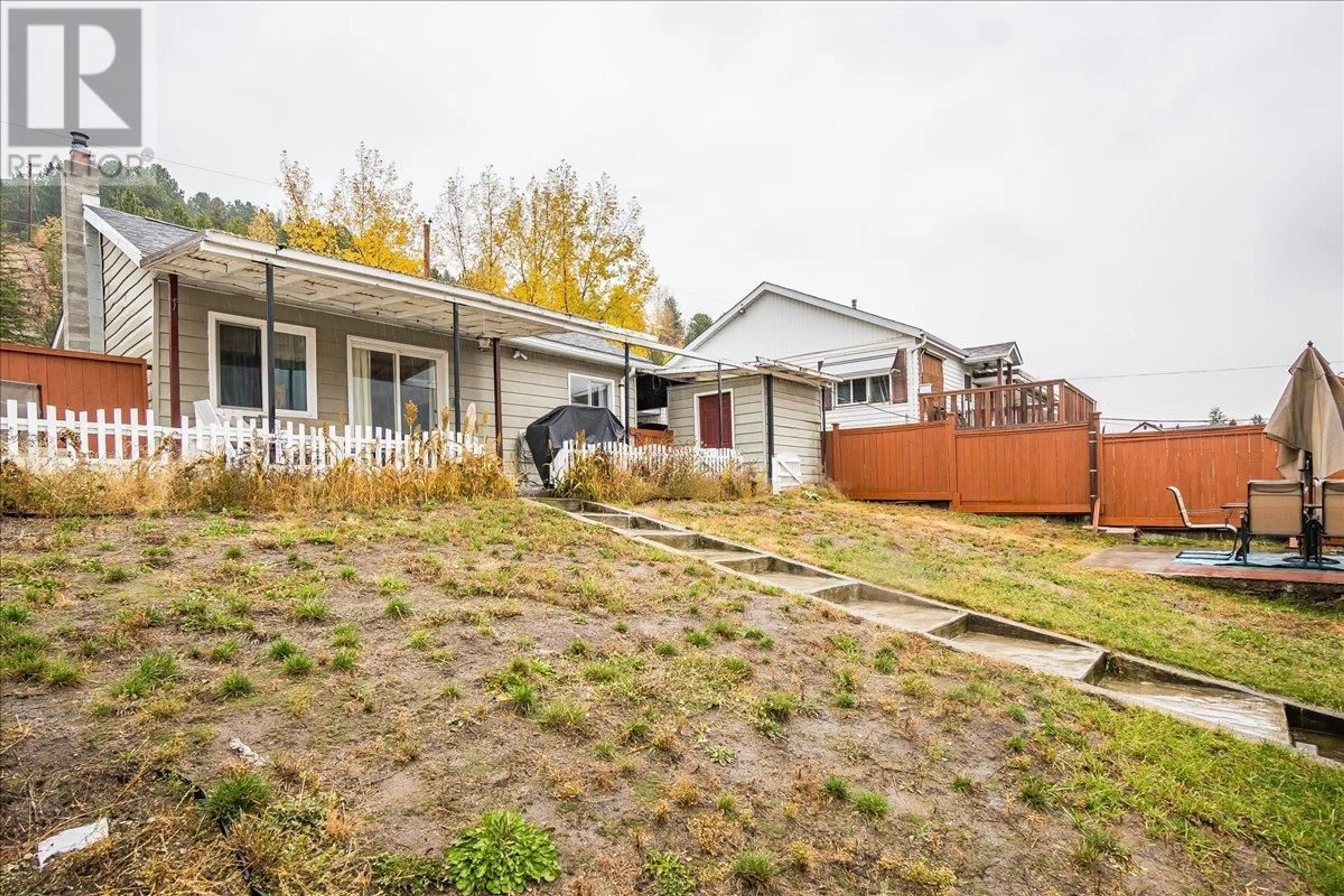 A pic from exterior of the house or condo, the fenced backyard for 2034 Eighth Avenue, Trail British Columbia V1R3E1