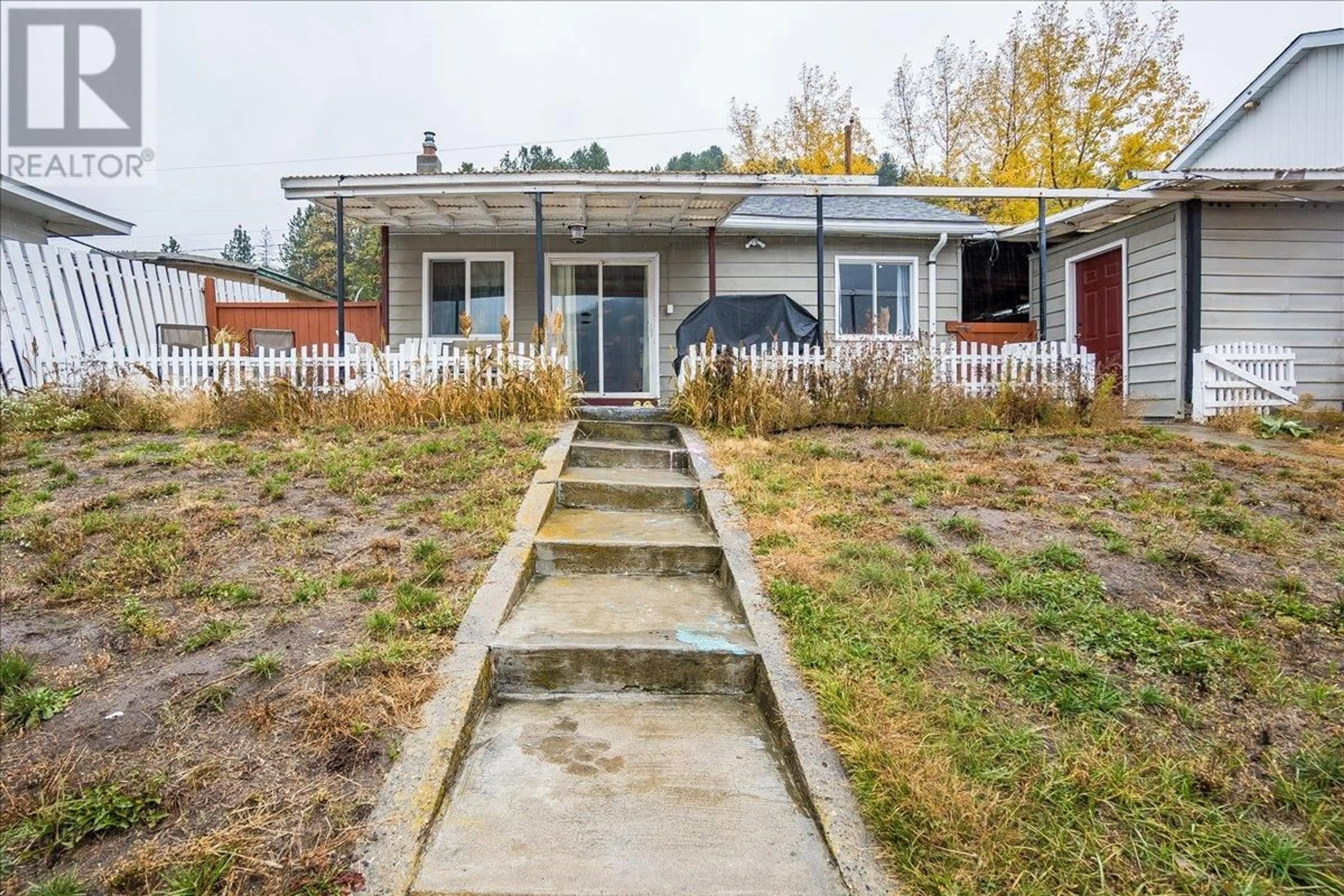 Frontside or backside of a home, the fenced backyard for 2034 Eighth Avenue, Trail British Columbia V1R3E1