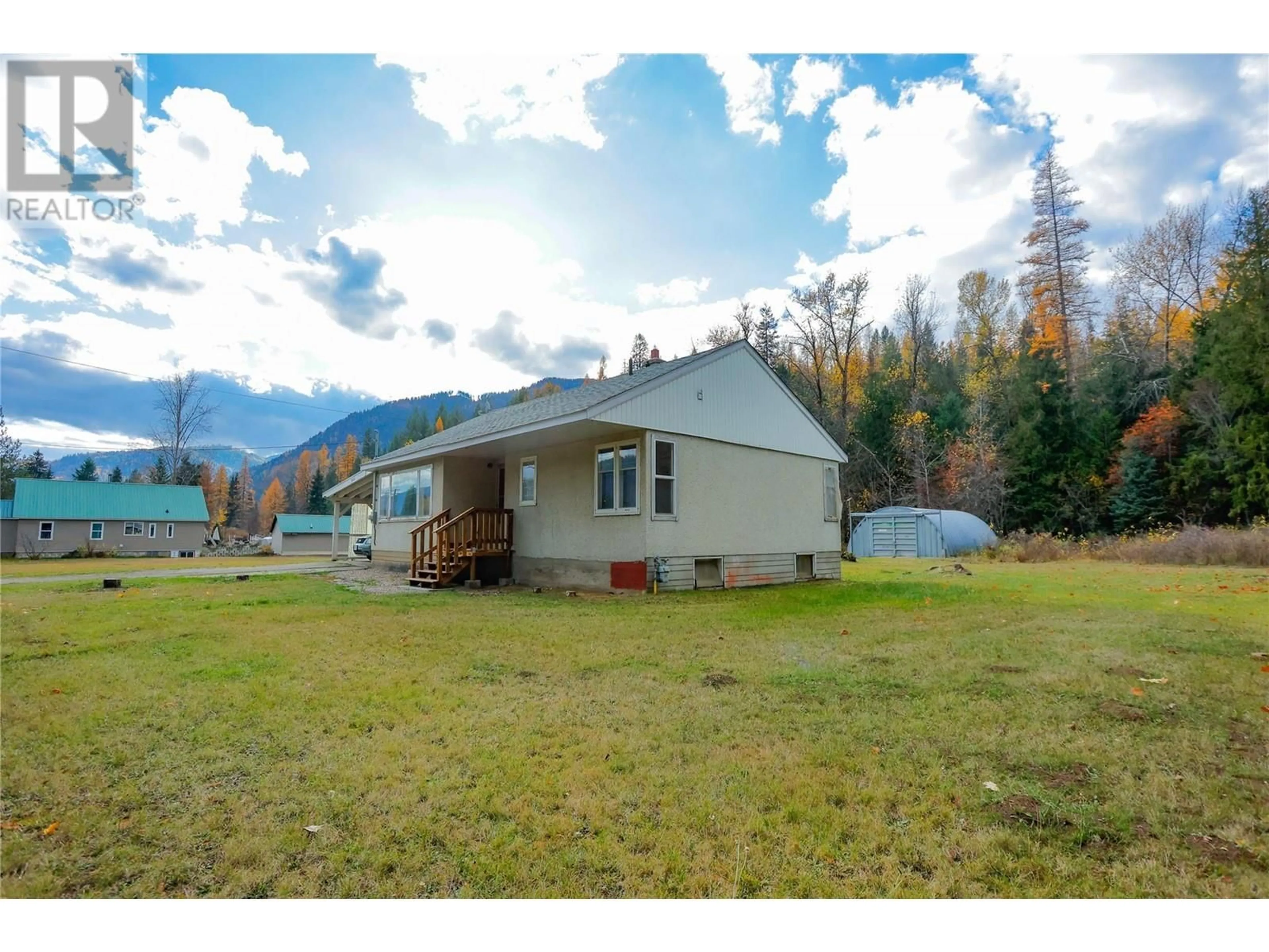 Frontside or backside of a home, the fenced backyard for 908 Glendale Avenue, Salmo British Columbia V0G1Z0