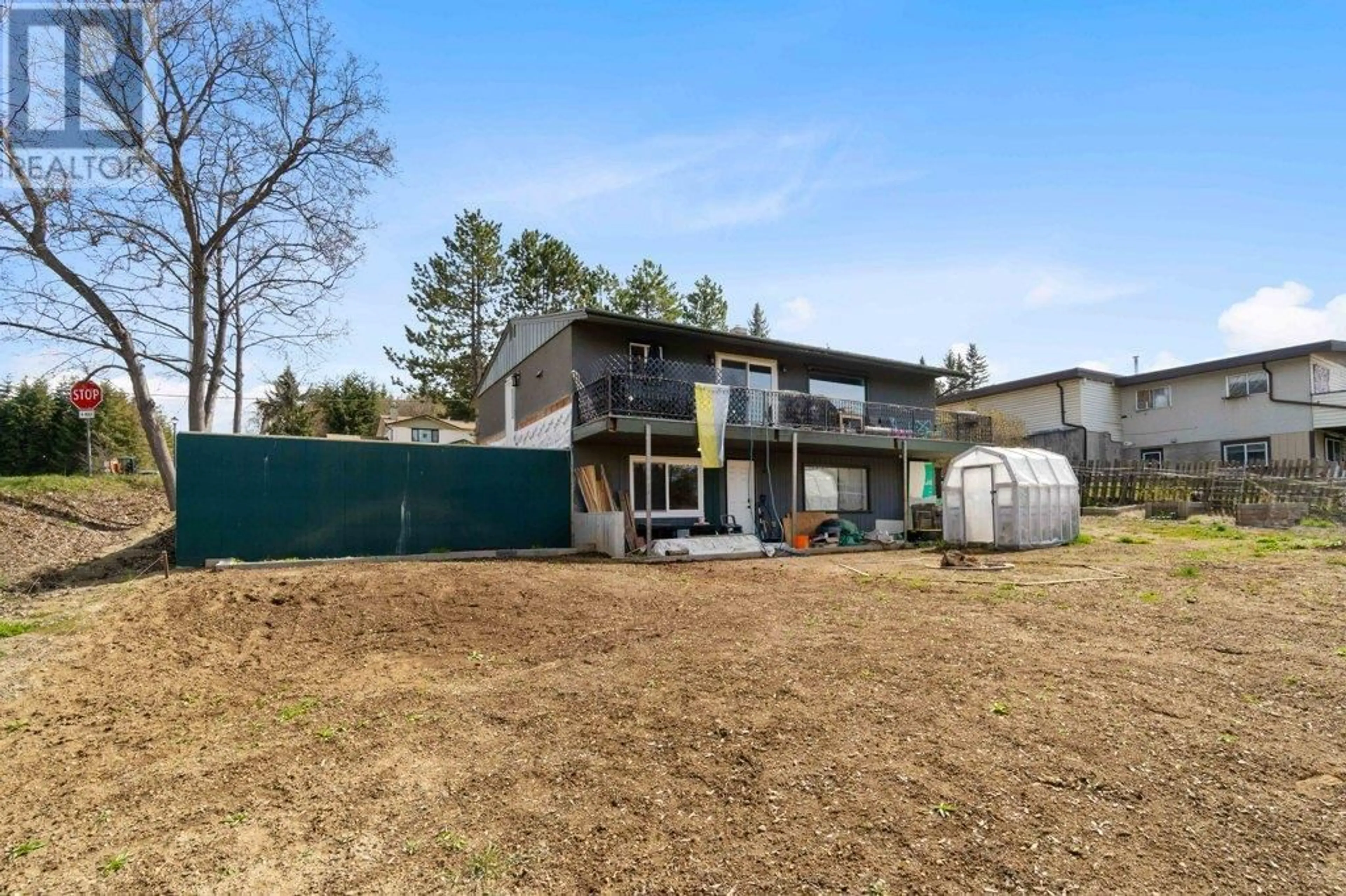 Frontside or backside of a home, the fenced backyard for 811 21 Street NE, Salmon Arm British Columbia V1E2K9