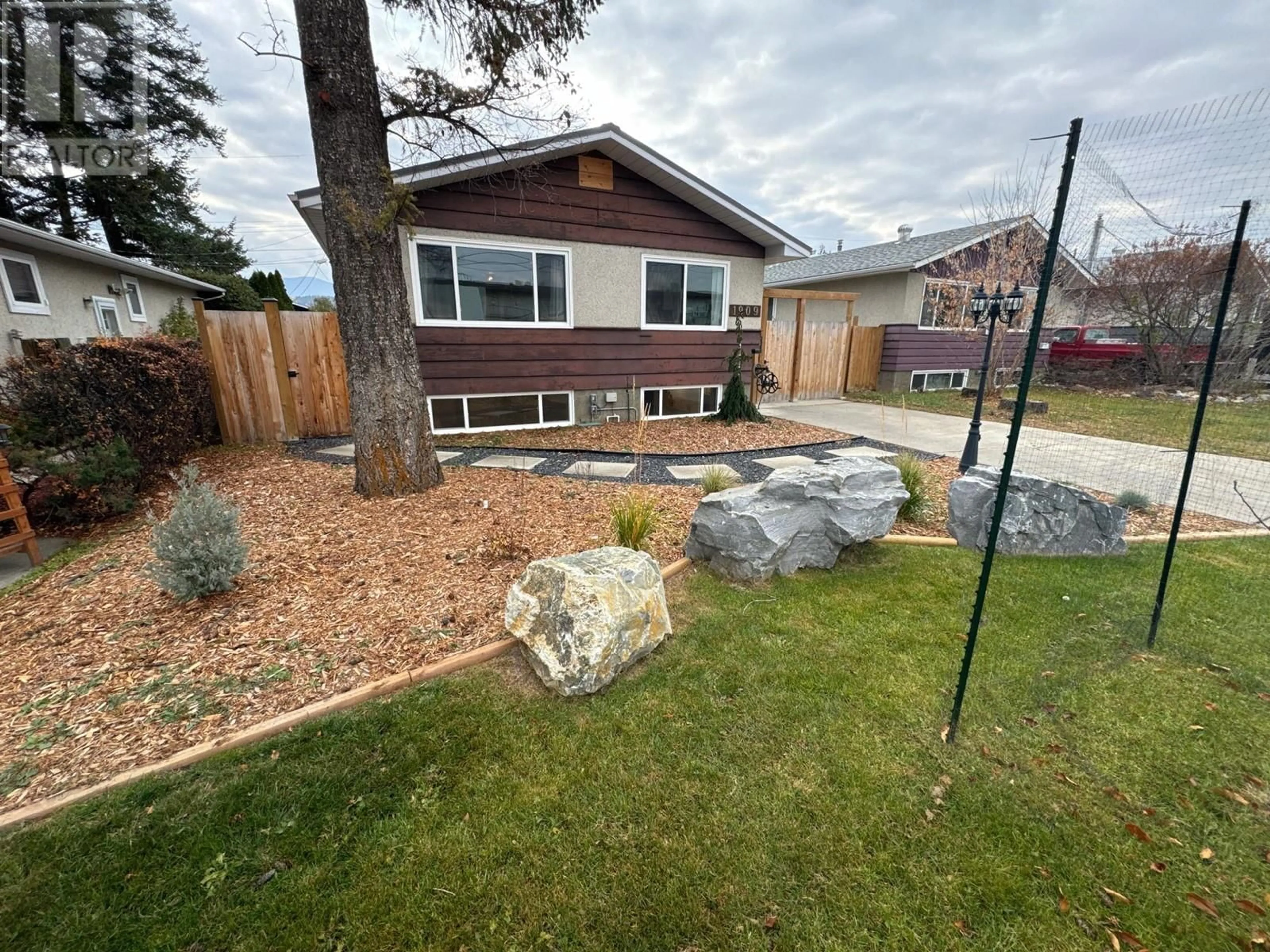 Frontside or backside of a home, the fenced backyard for 1909 2ND Street S, Cranbrook British Columbia V1C1C6