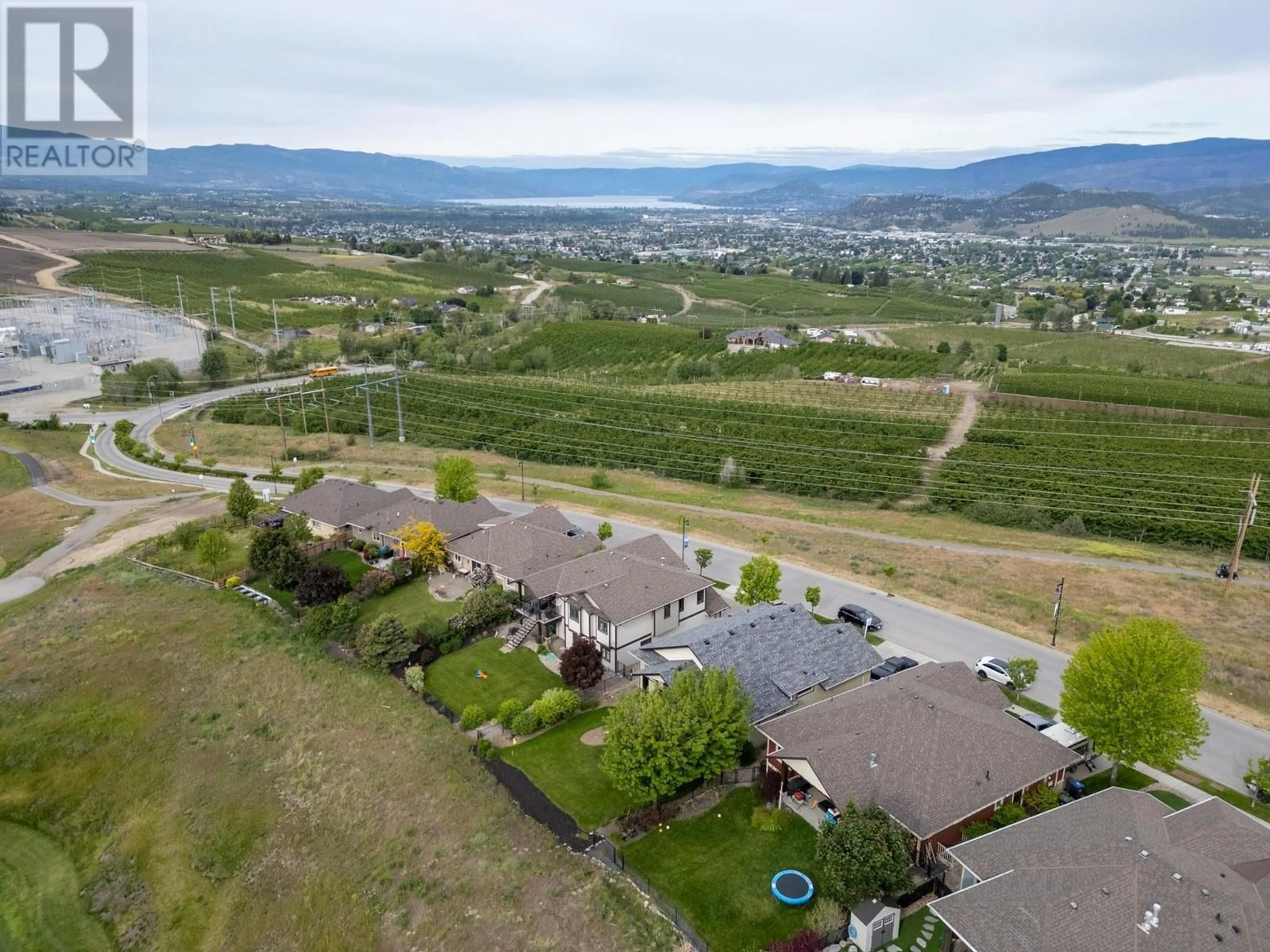 Frontside or backside of a home, the fenced backyard for 1585 Tower Ranch Boulevard, Kelowna British Columbia V1P1P9