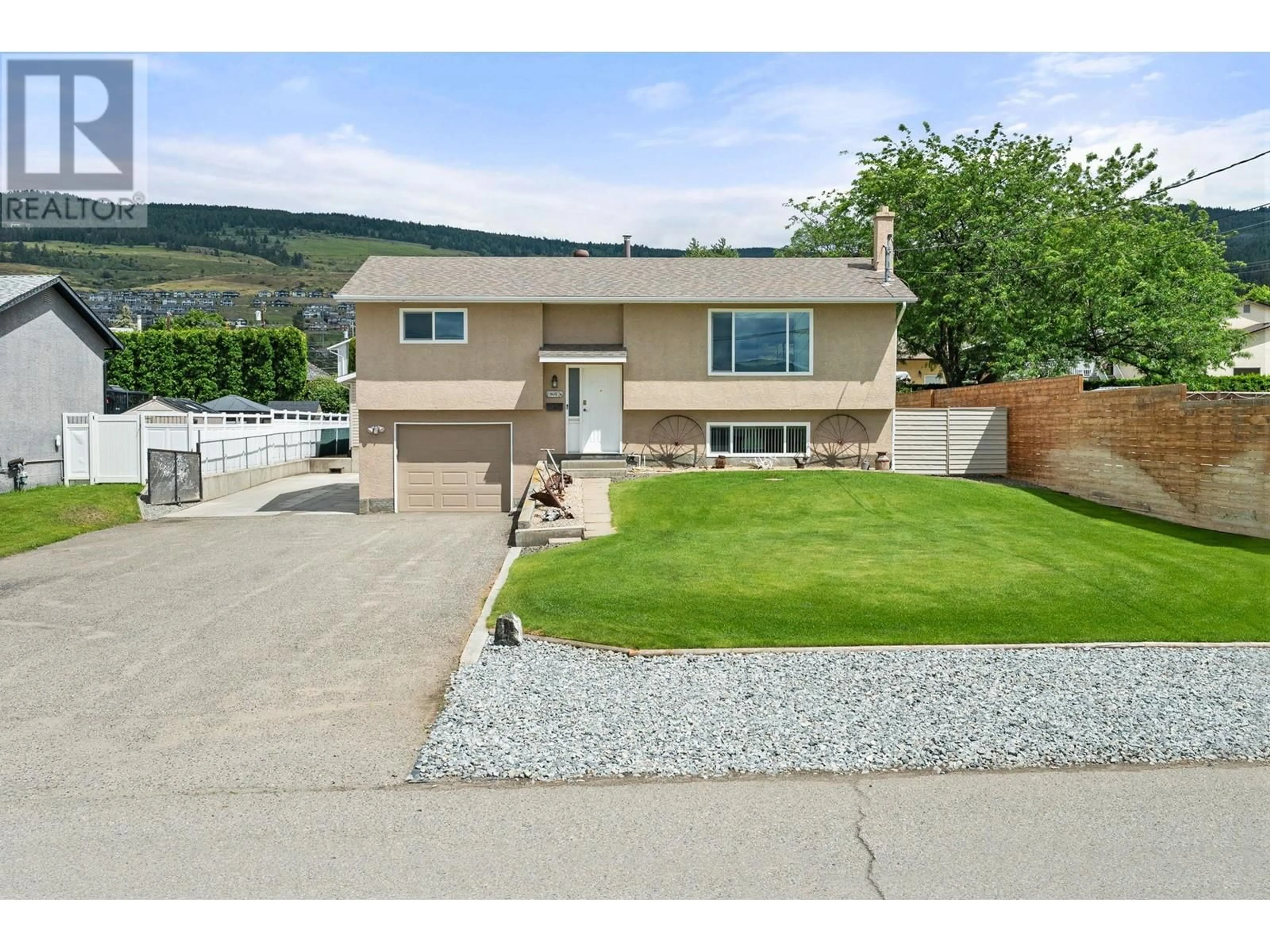 Frontside or backside of a home, the fenced backyard for 3641 Weston Road, Kelowna British Columbia V1X6S9