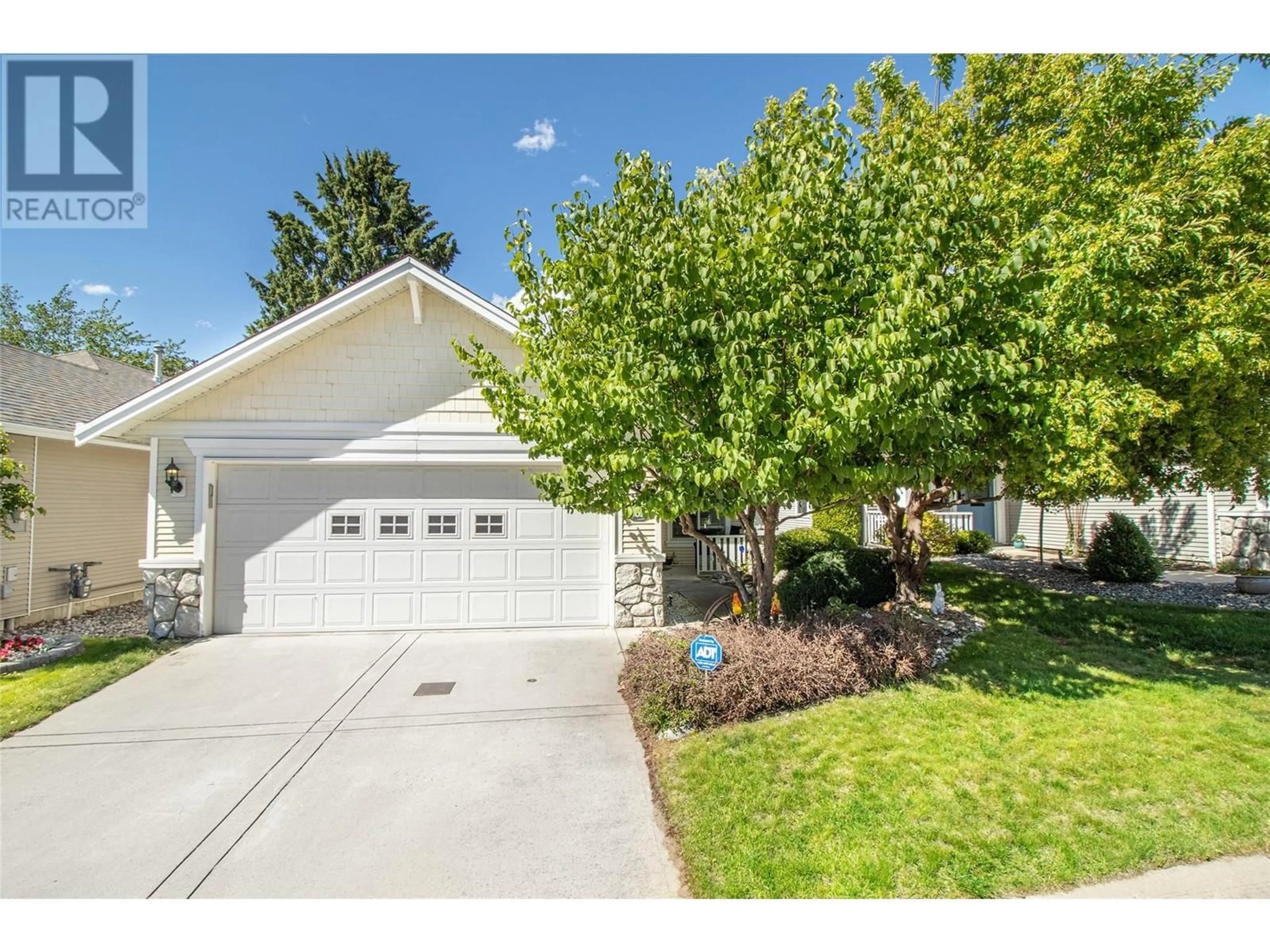 Frontside or backside of a home, the fenced backyard for 1321 Ridgeway Drive Unit# 102, Kelowna British Columbia V1Y9T6