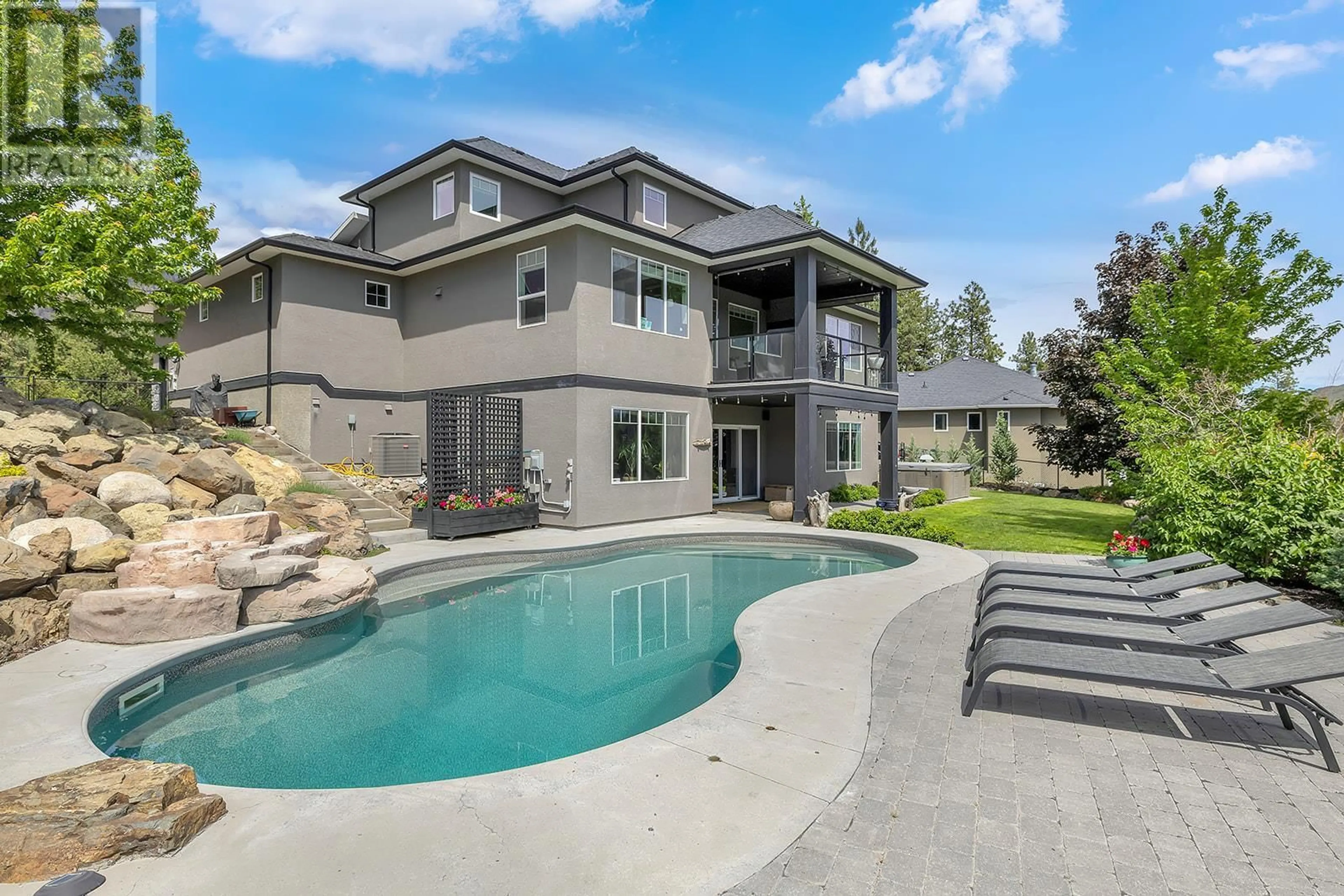 Frontside or backside of a home, the fenced backyard for 2488 Stone Grove Crescent, West Kelowna British Columbia V4T3A8