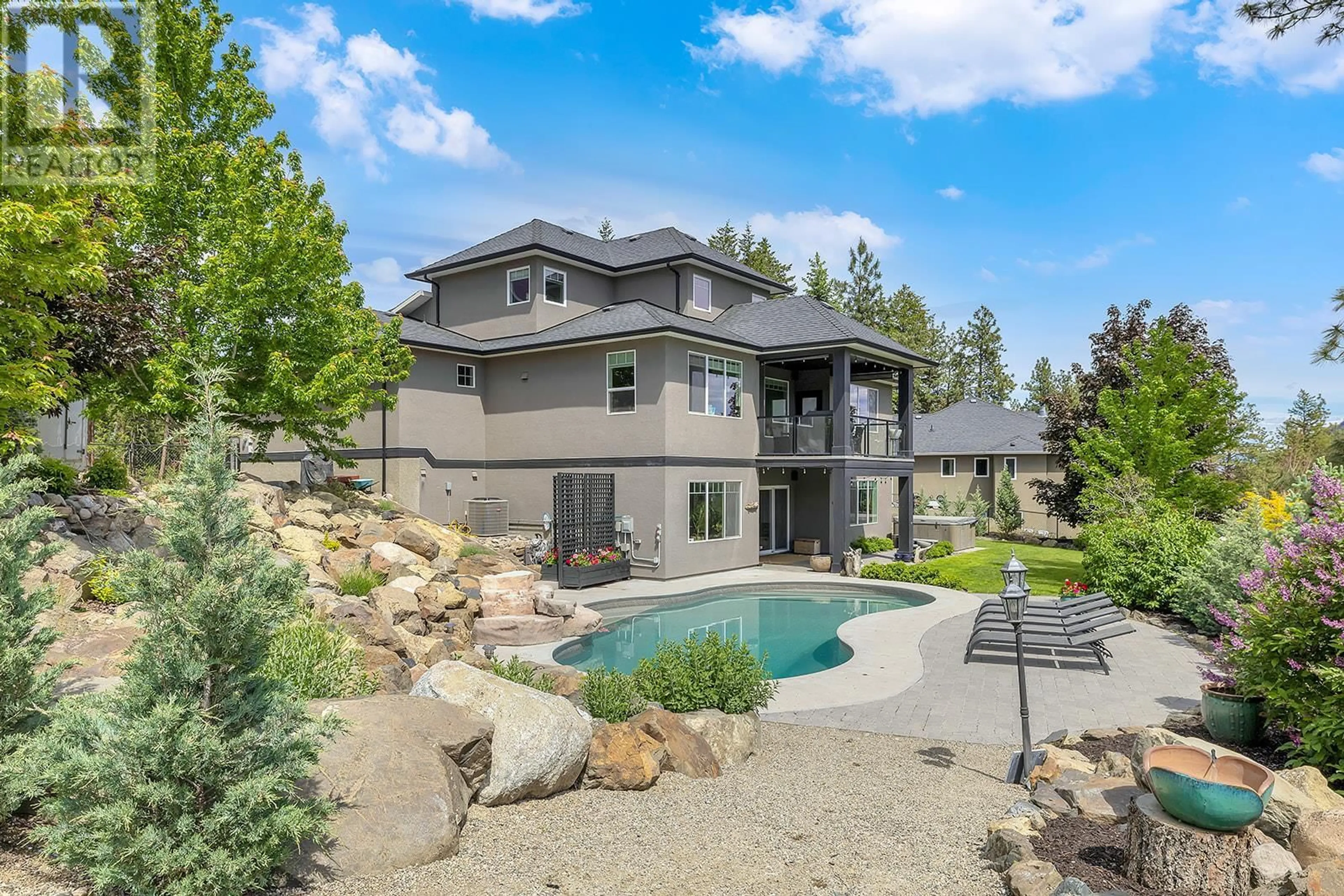 Frontside or backside of a home, the fenced backyard for 2488 Stone Grove Crescent, West Kelowna British Columbia V4T3A8