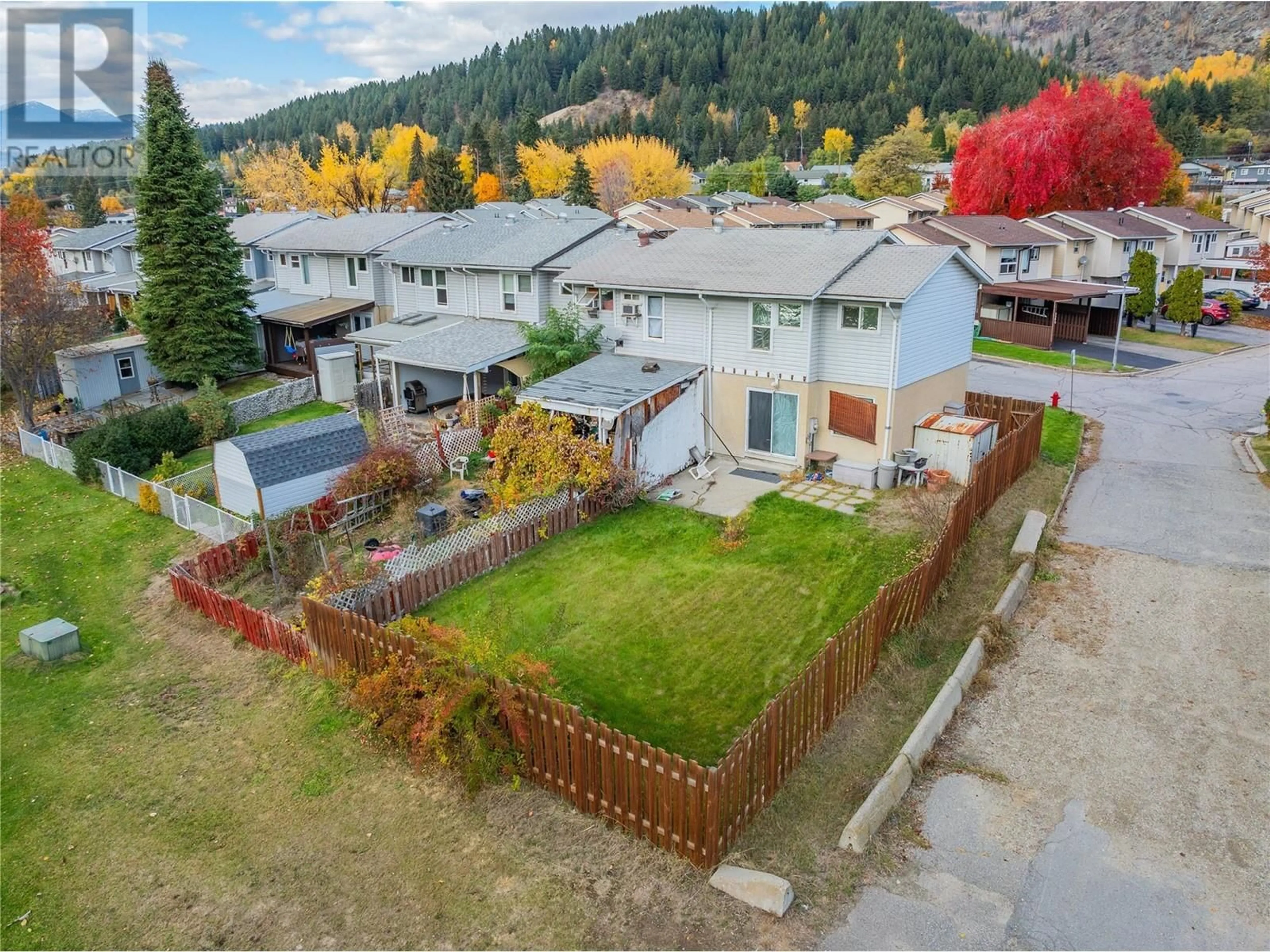 Frontside or backside of a home, the fenced backyard for 3362 Laurel Crescent, Trail British Columbia V1R4M5