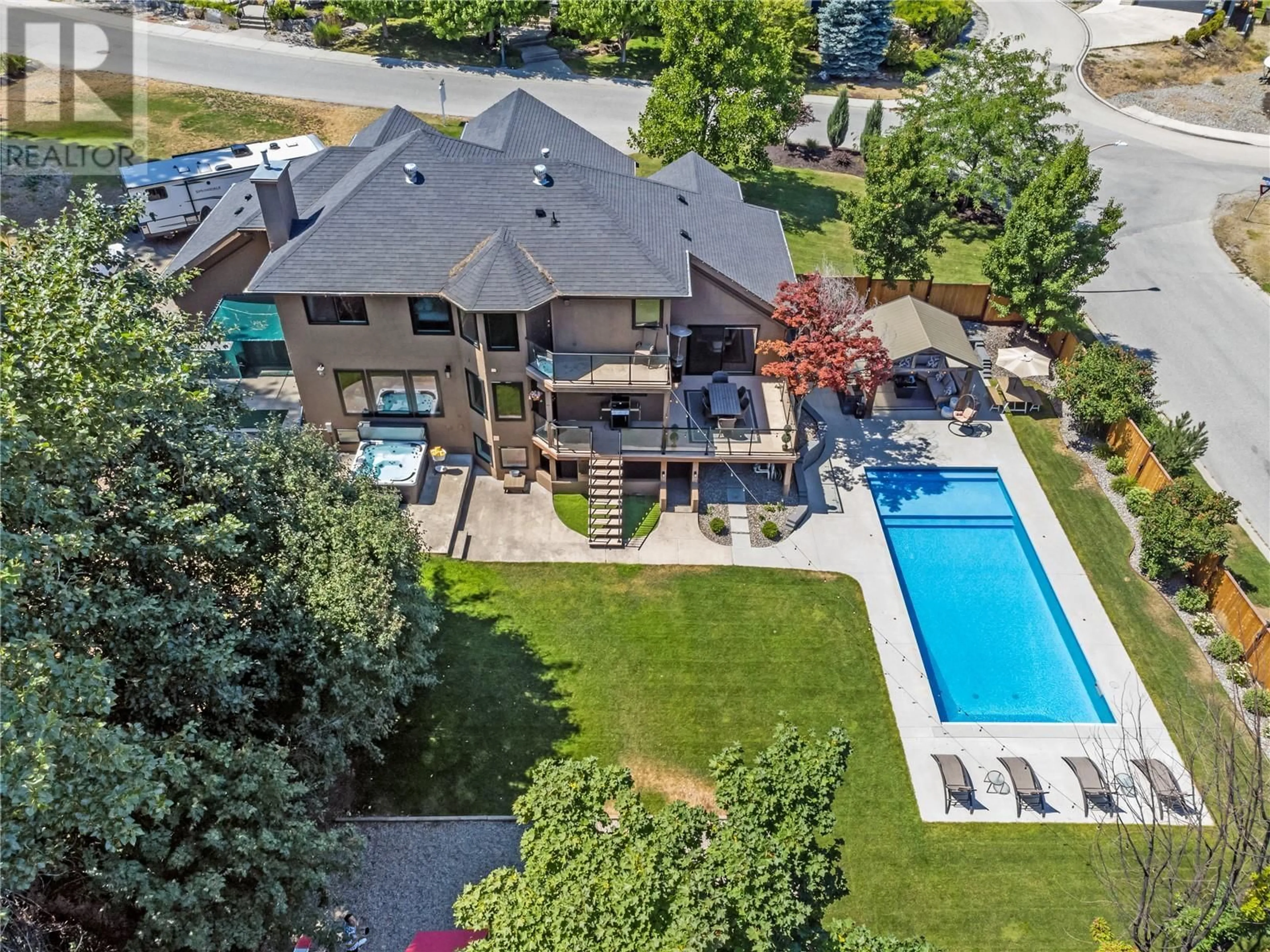 Frontside or backside of a home, the fenced backyard for 5327 Hedeman Court, Kelowna British Columbia V1W5A3