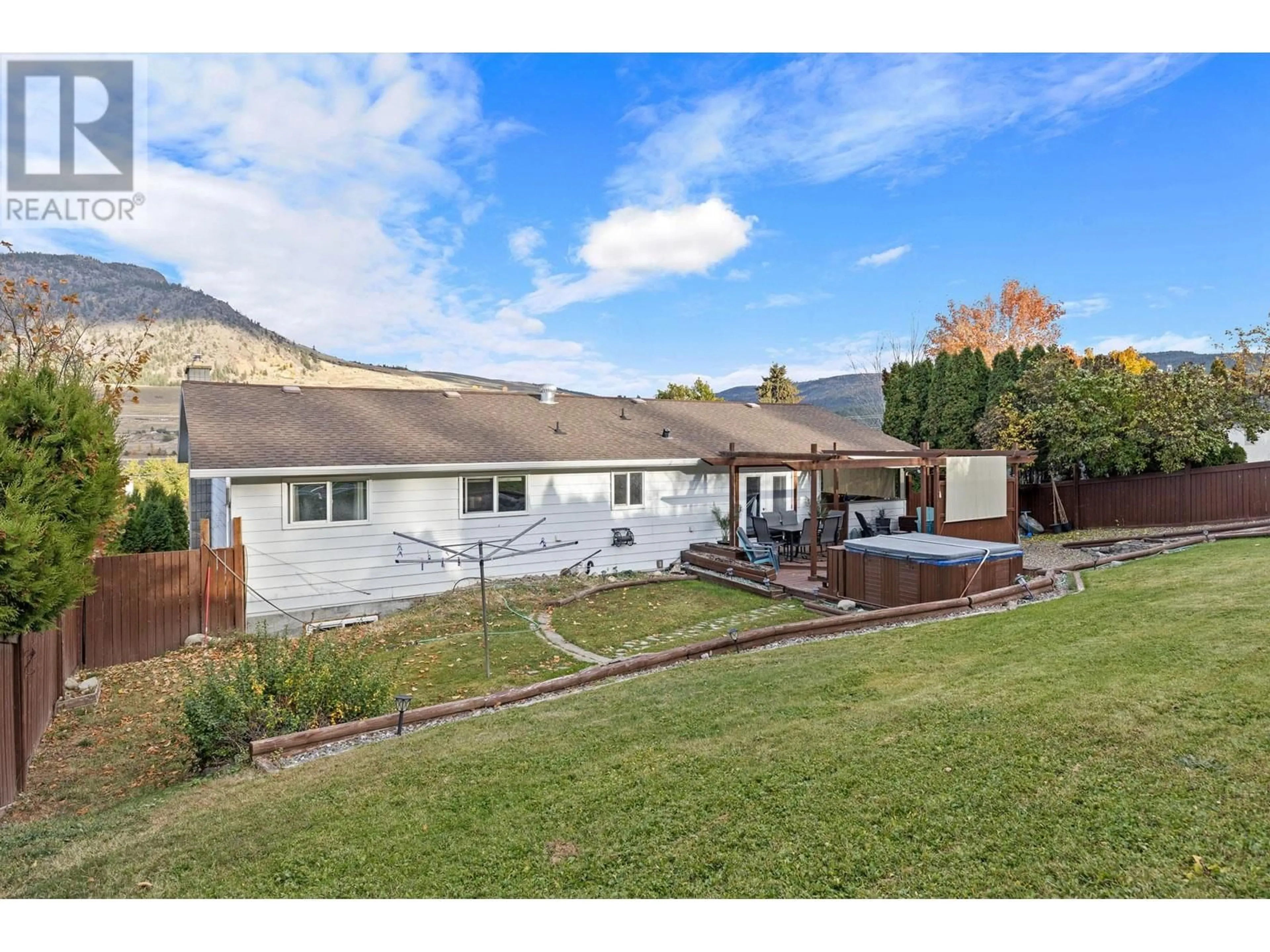 Frontside or backside of a home, the fenced backyard for 2196 Lynrick Road, Kelowna British Columbia V1P1G4