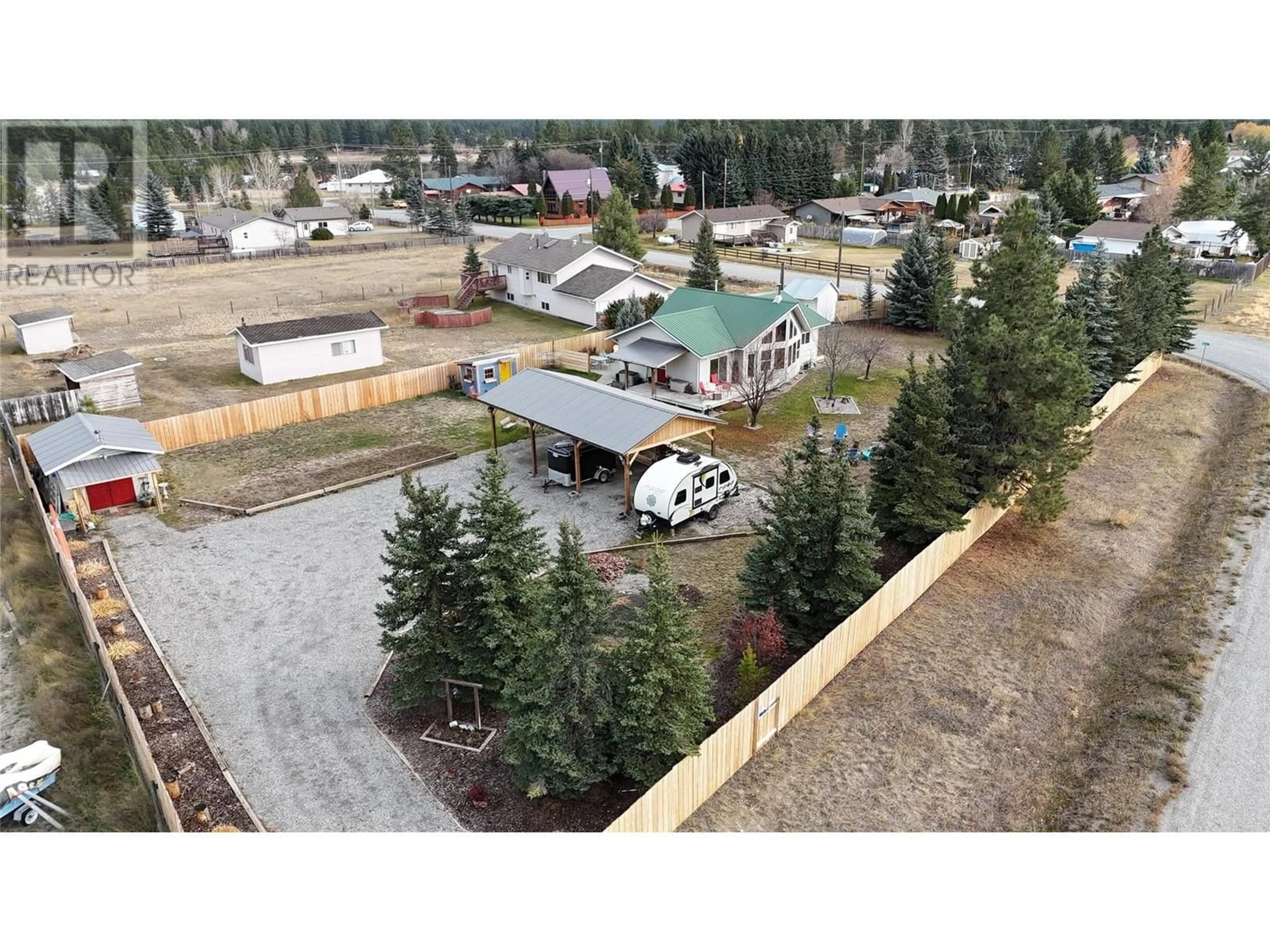 Frontside or backside of a home, the fenced backyard for 4651 Willow Road, Wasa British Columbia V0B2K0