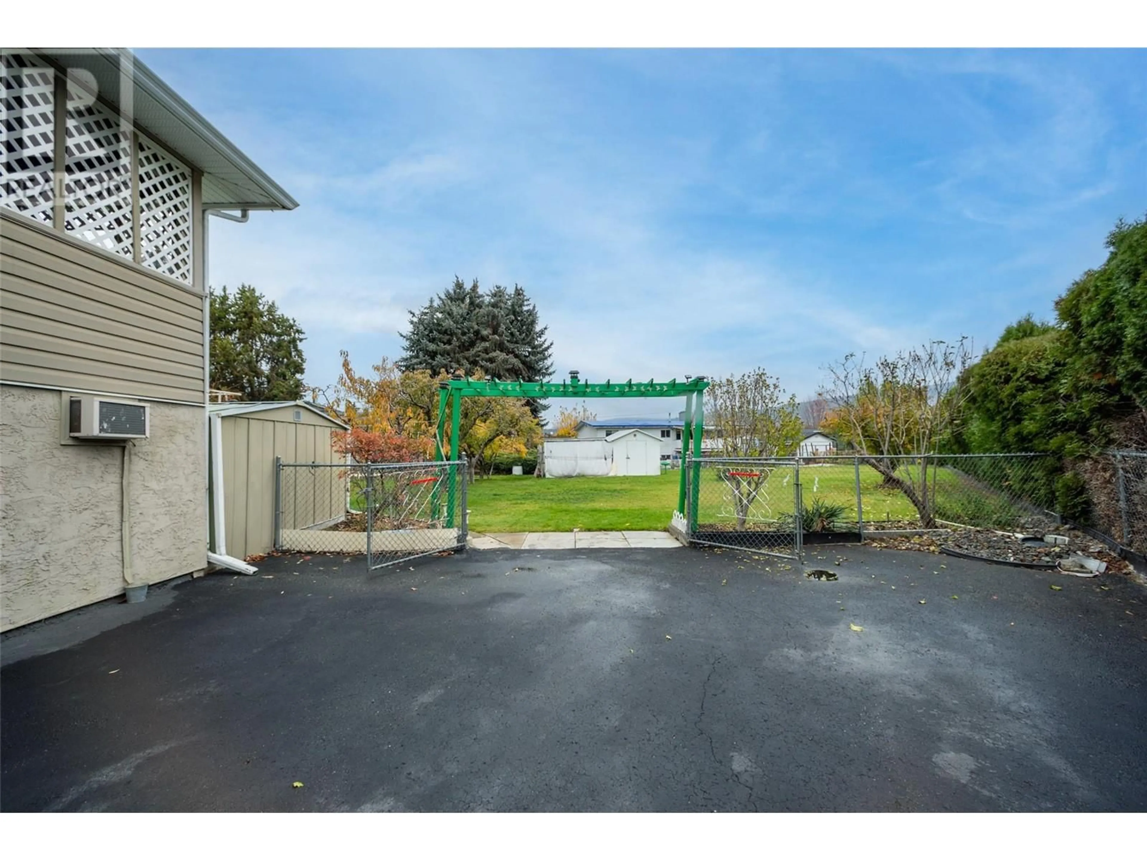 Patio, the fenced backyard for 1251 Ortt Place, Kelowna British Columbia V1X4Y8