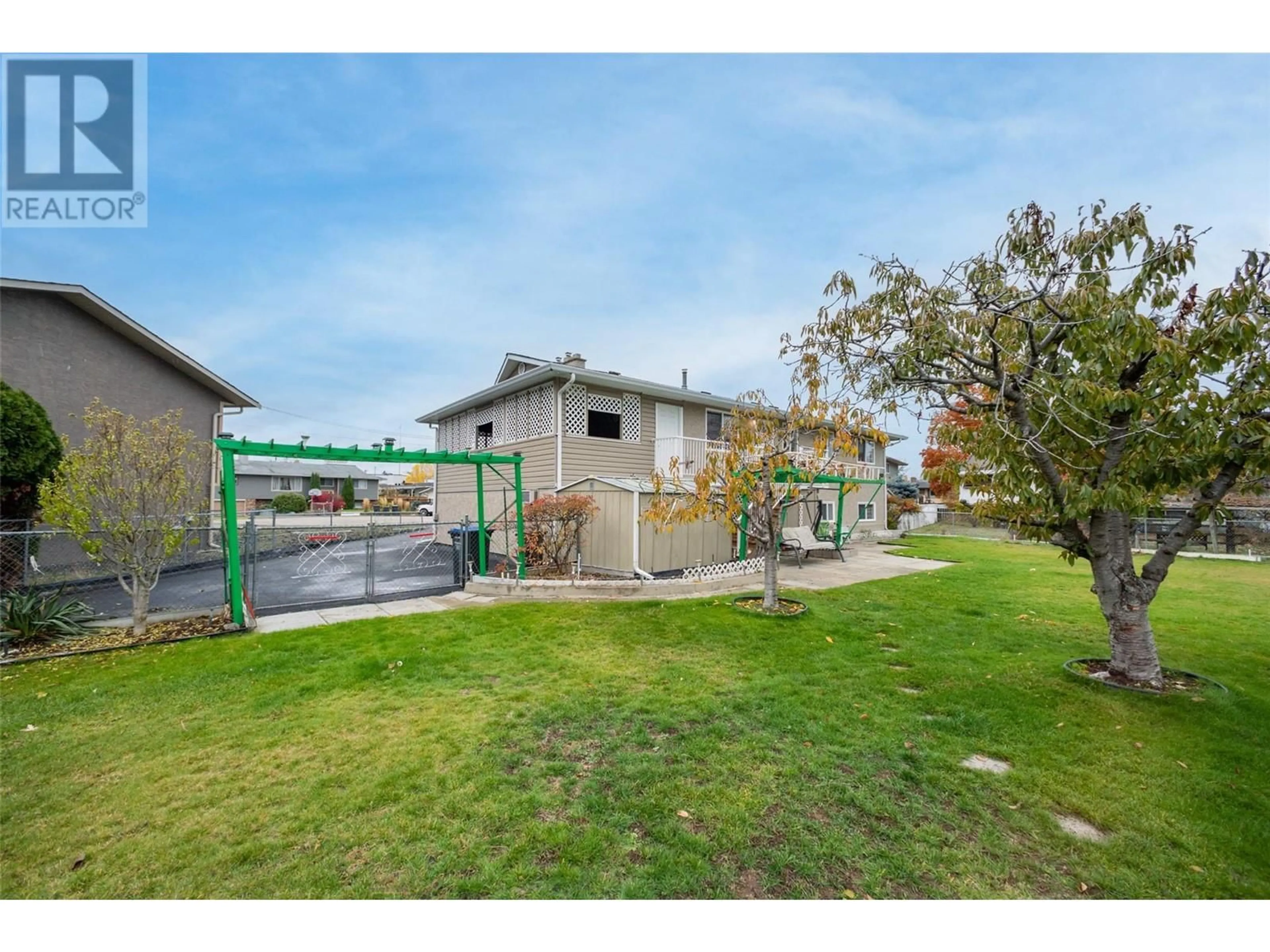 Frontside or backside of a home, the fenced backyard for 1251 Ortt Place, Kelowna British Columbia V1X4Y8