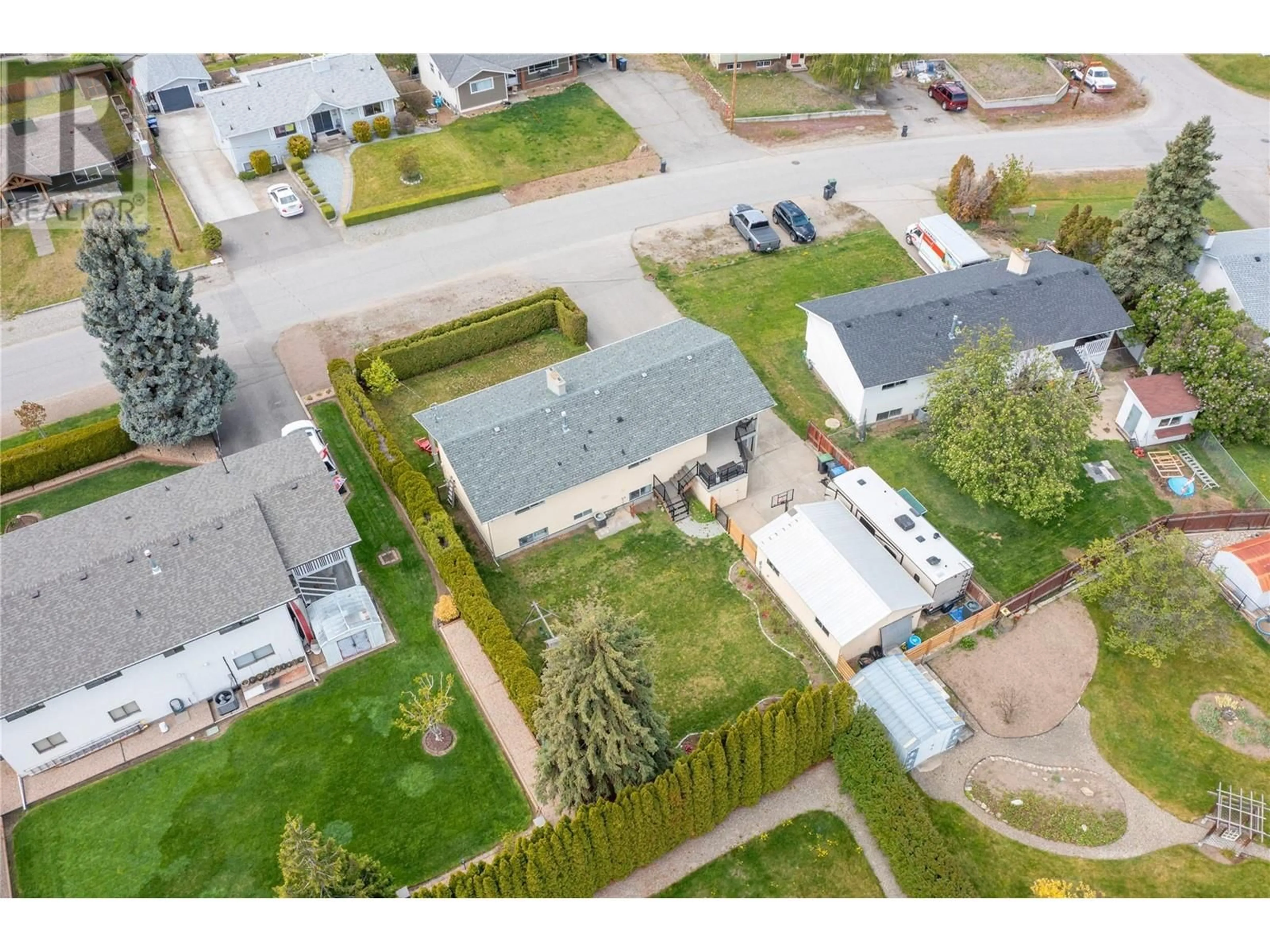 Frontside or backside of a home, the fenced backyard for 1845 Hayashi Road, Kelowna British Columbia V1P1A7