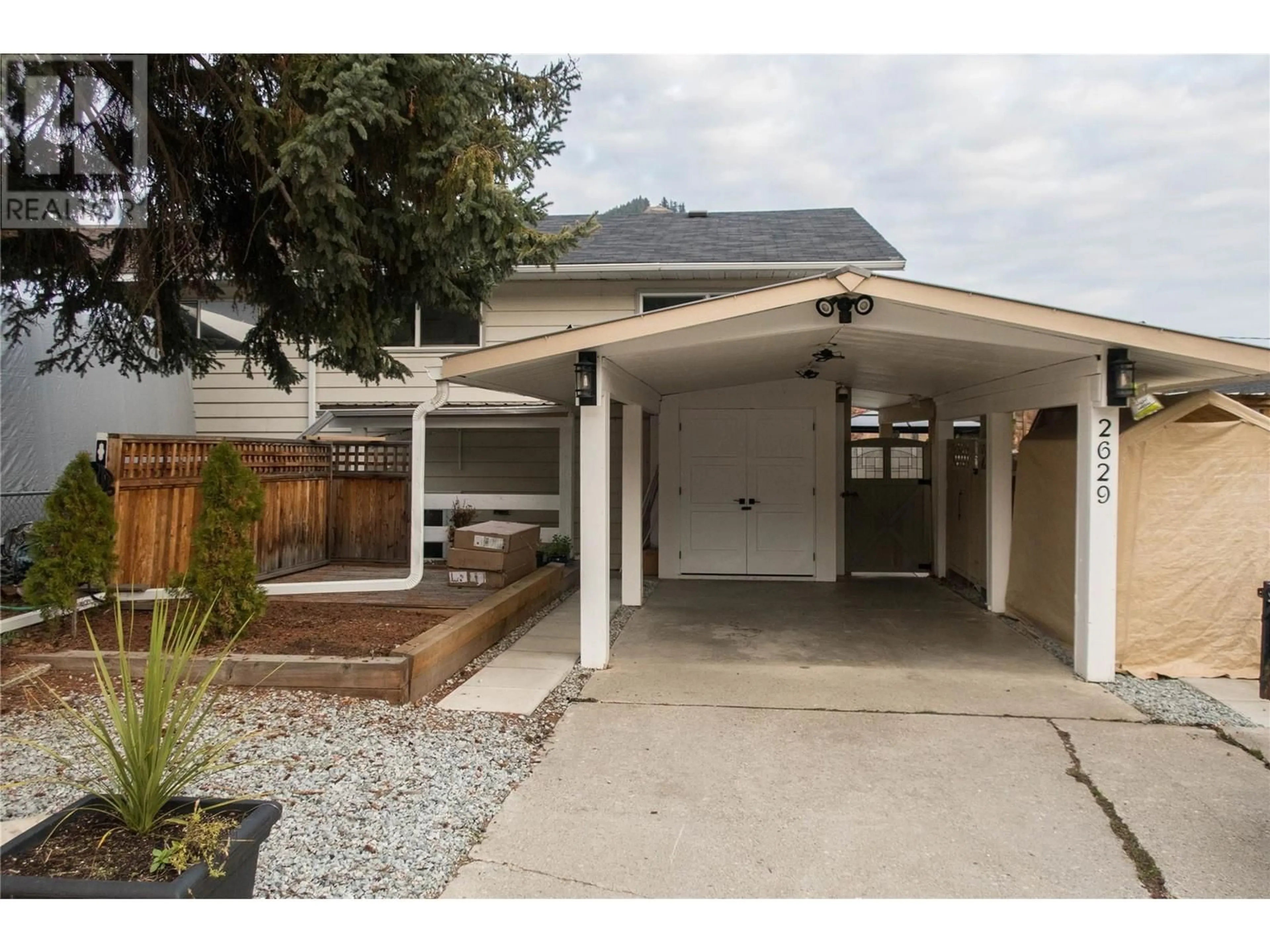 Frontside or backside of a home, the fenced backyard for 2629 Balsam Lane, Lumby British Columbia V0E2G5