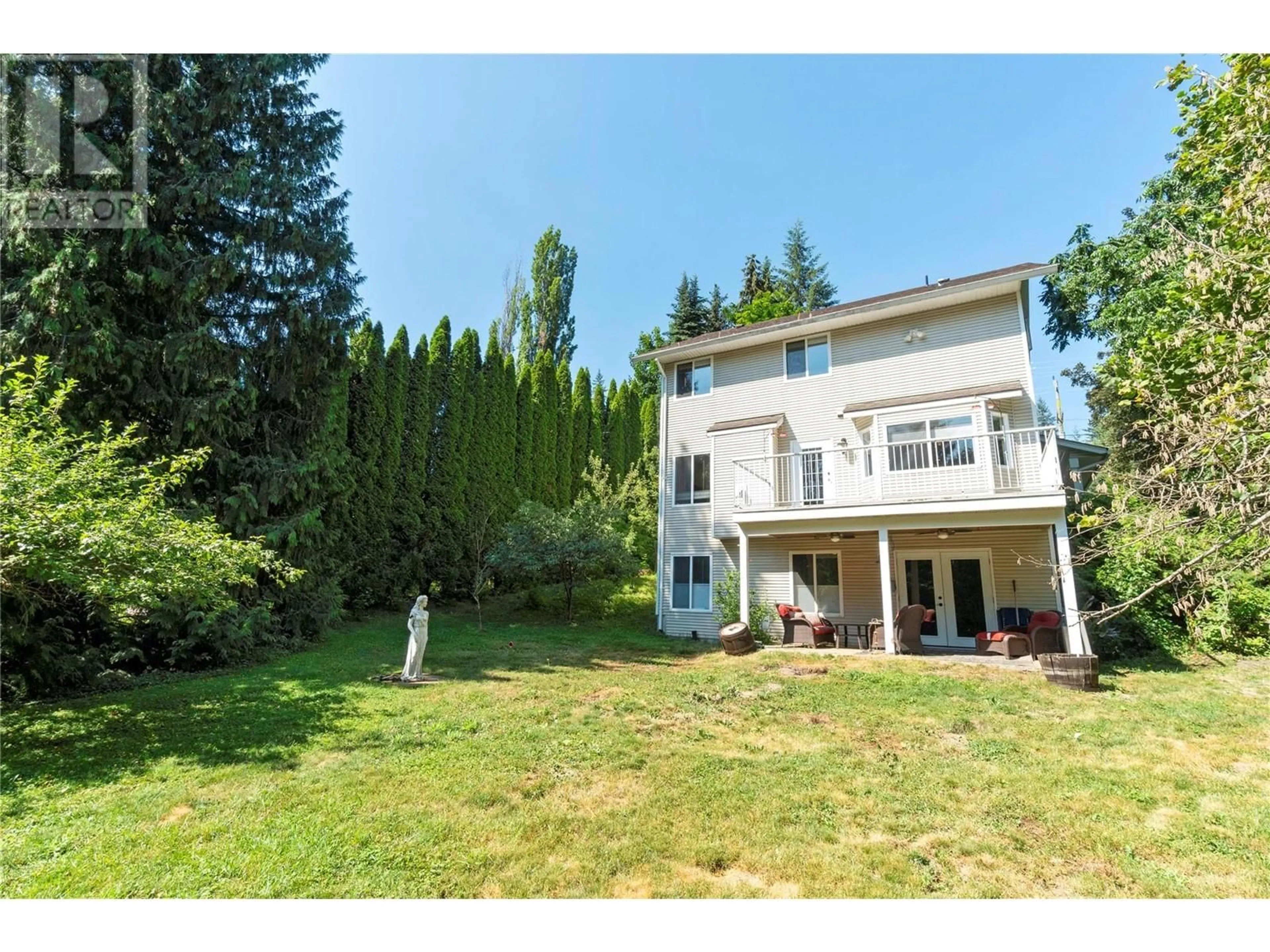 Frontside or backside of a home, the fenced backyard for 410 97B Highway NE, Salmon Arm British Columbia V1E1X5