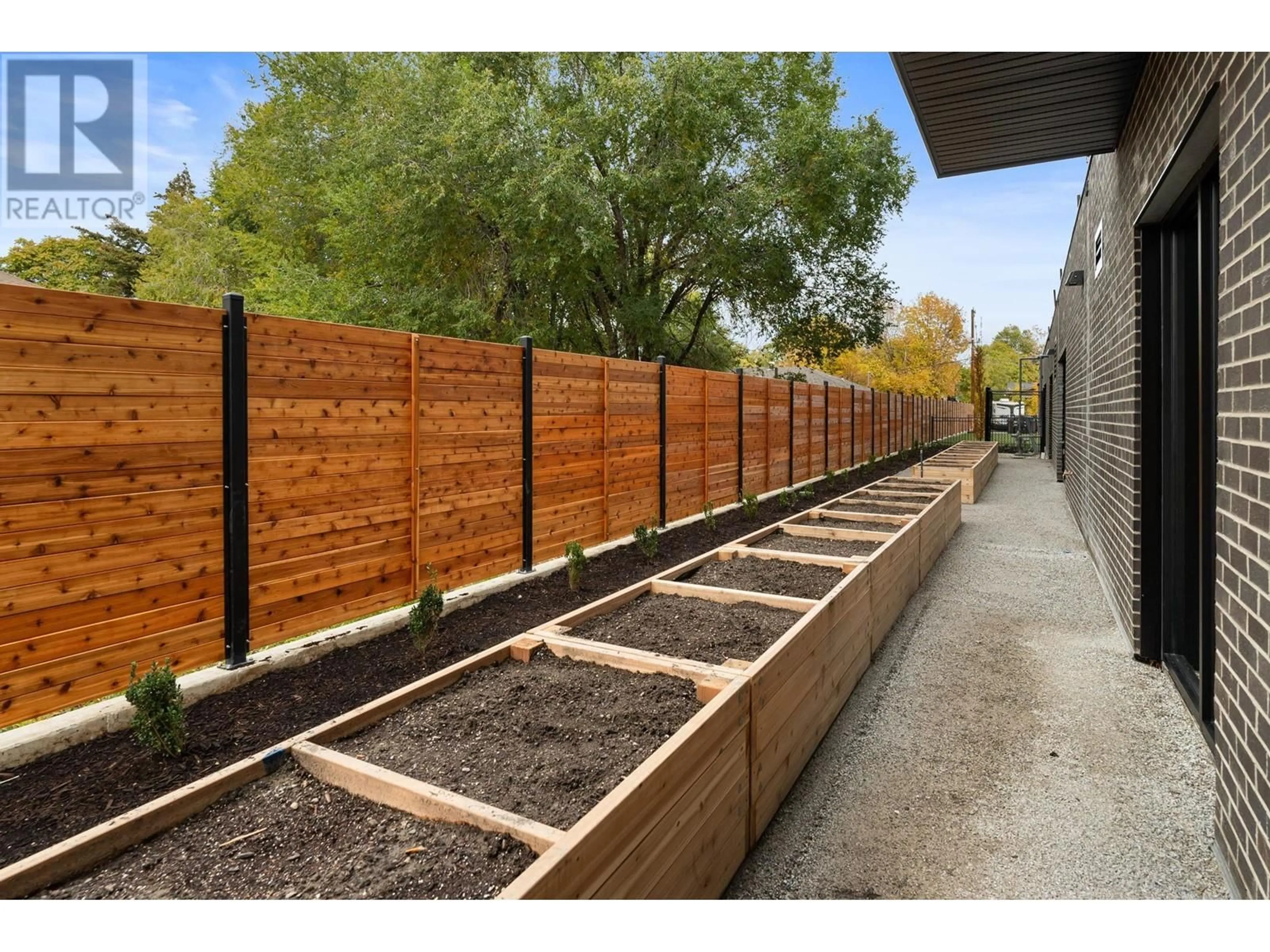 Patio, the fenced backyard for 1274 Devonshire Avenue Unit# 203, Kelowna British Columbia V1Y6B7