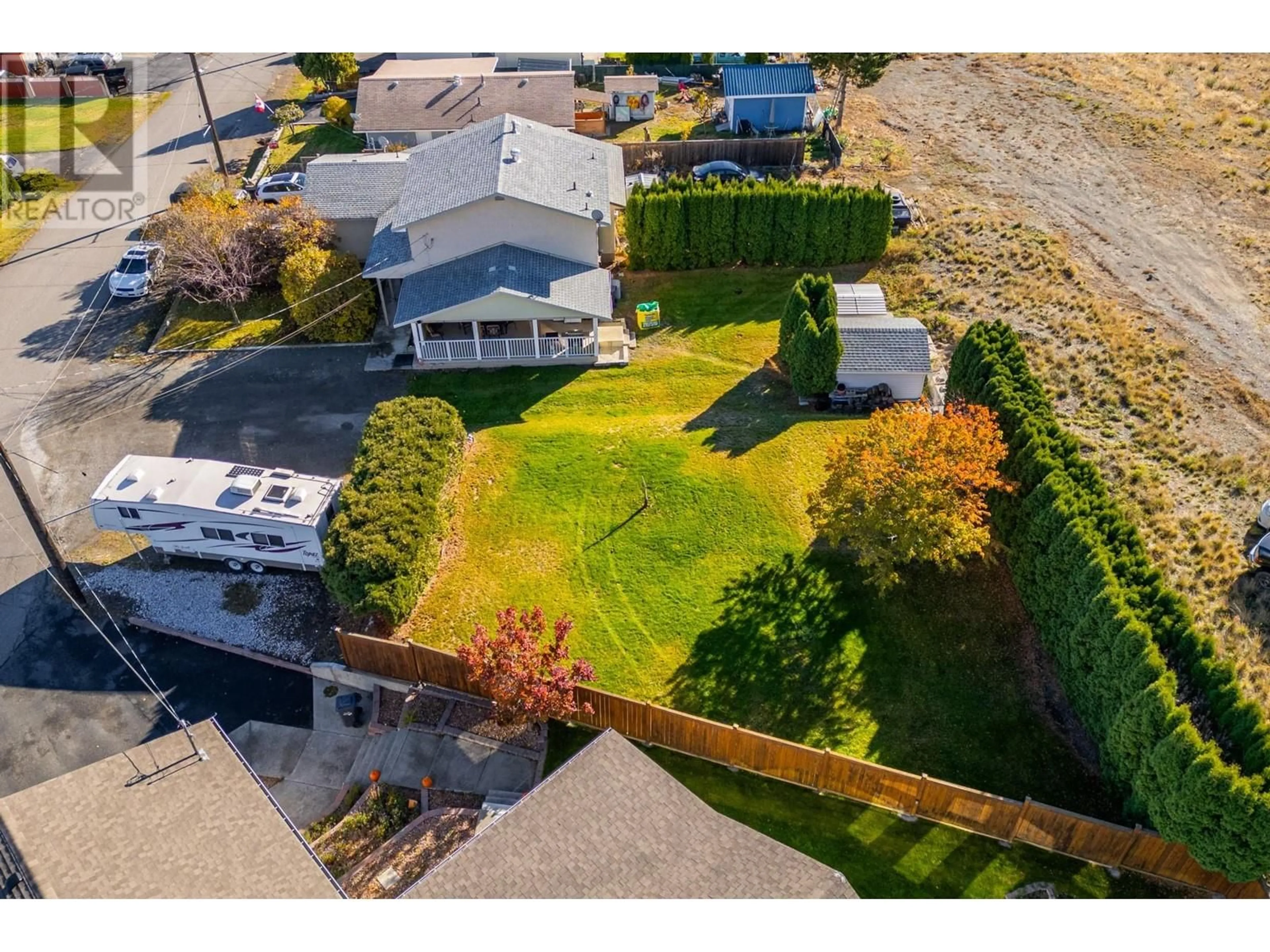 Frontside or backside of a home, the fenced backyard for 1427 PINE Avenue, Ashcroft British Columbia V0K1A0