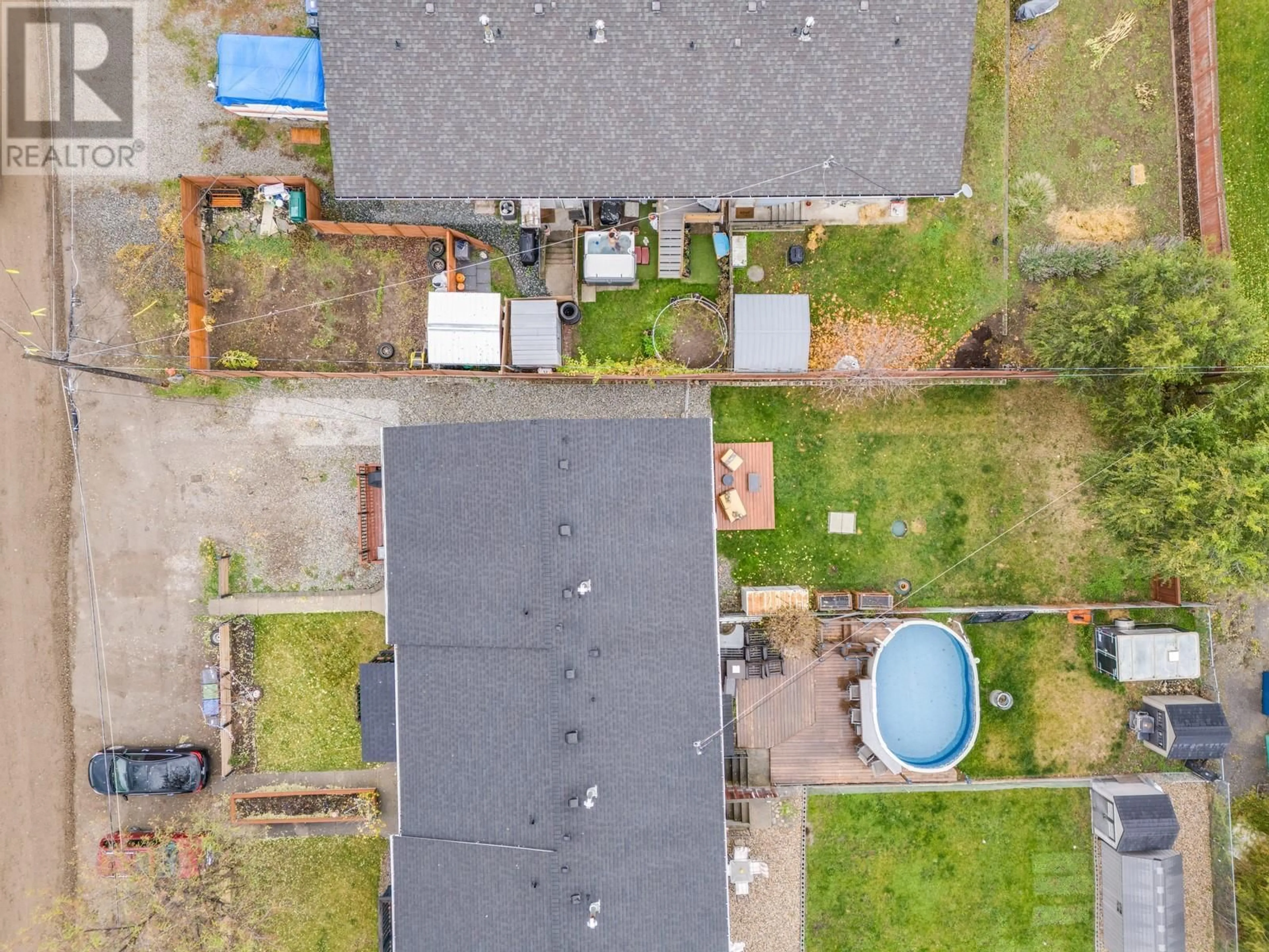 Frontside or backside of a home, the fenced backyard for 190 Scarboro Road, Kelowna British Columbia V1X1M2